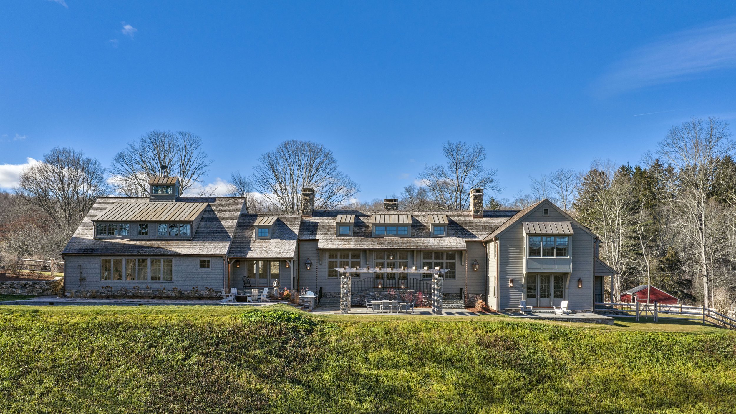  The rear elevation of the home reveals the full scope of the additions, designed to complement the original architecture. 