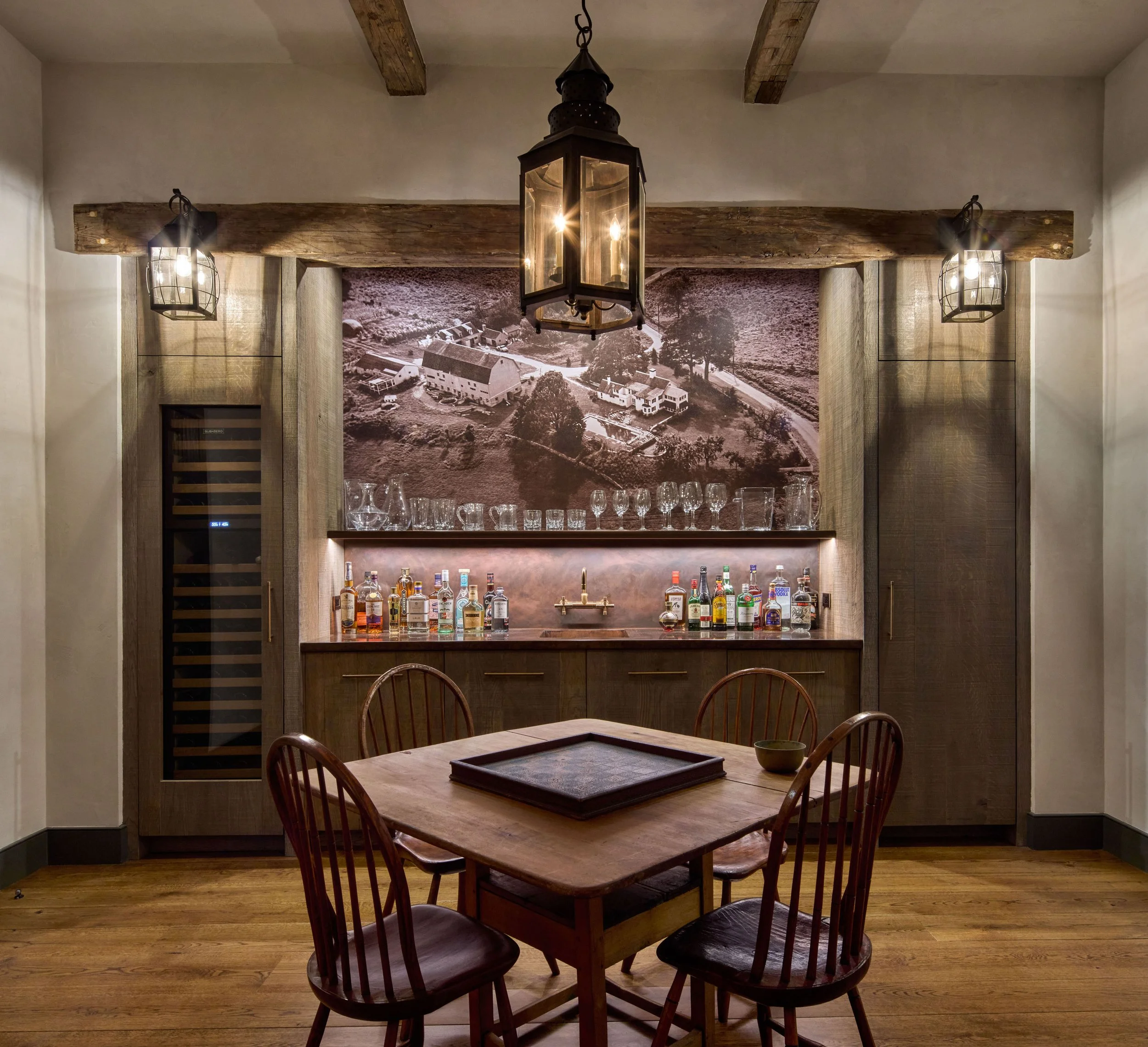  A rustic pub is the center gathering space for this new family entertainment center, serving an adjacent media room and golf simulator room. 