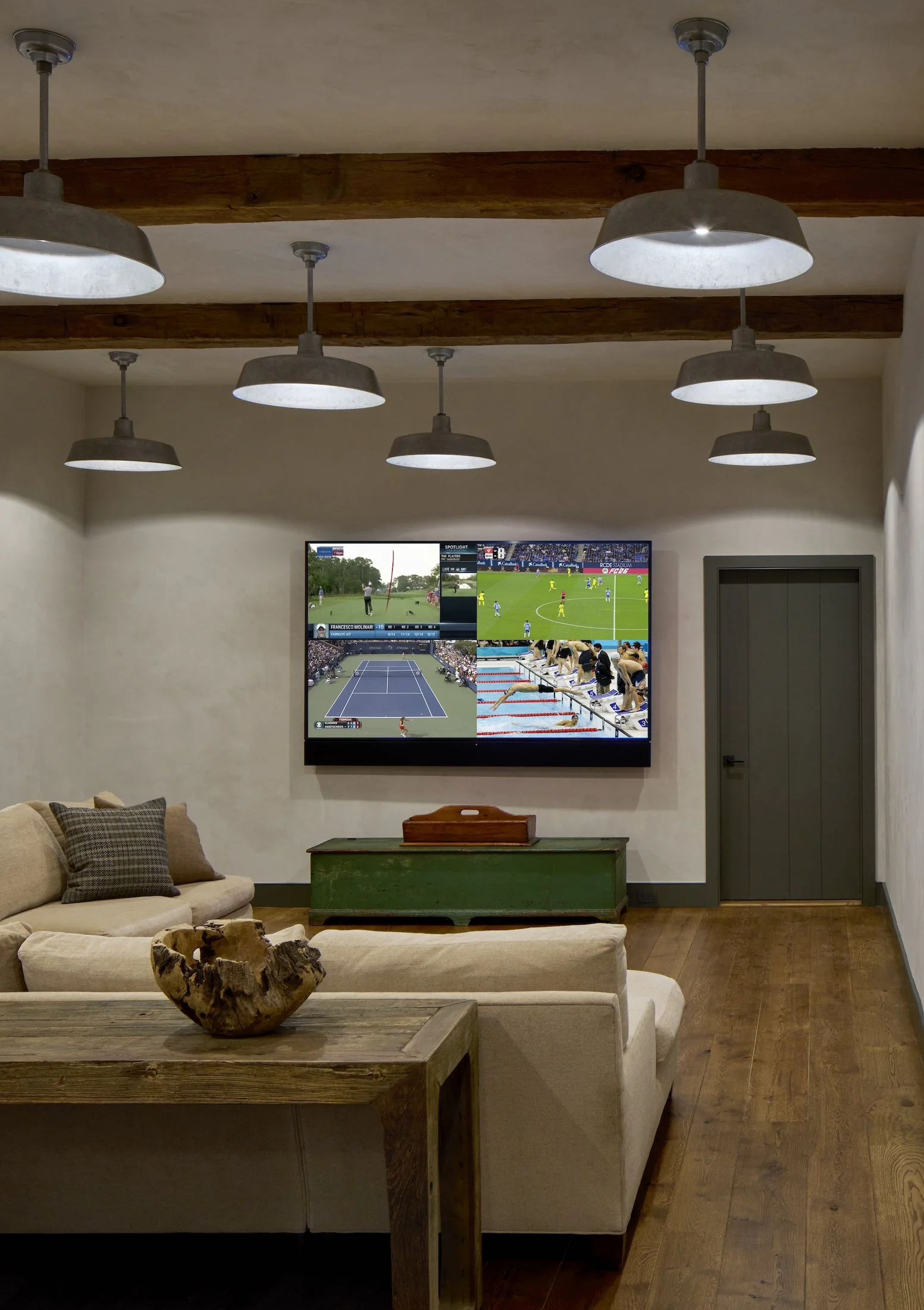  Antique hand-hewn beams and galvanized metal barn lights add character to the Media Room. 