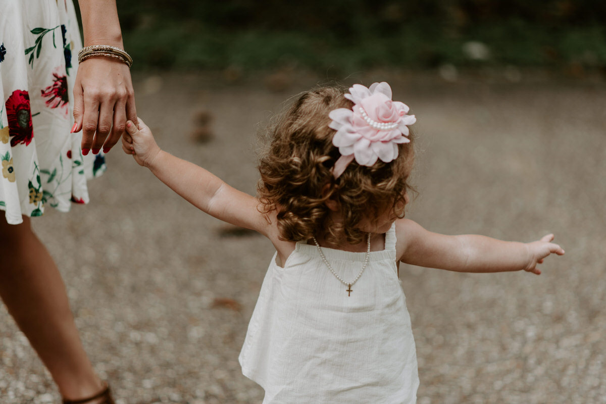 Sweet family and surprise proposal session in st. francisville, louisiana at rosedown plantation with gorgeous oak trees photographed by magnolia and grace photography