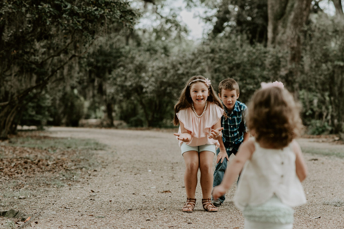 Sweet family and surprise proposal session in st. francisville, louisiana at rosedown plantation with gorgeous oak trees photographed by magnolia and grace photography