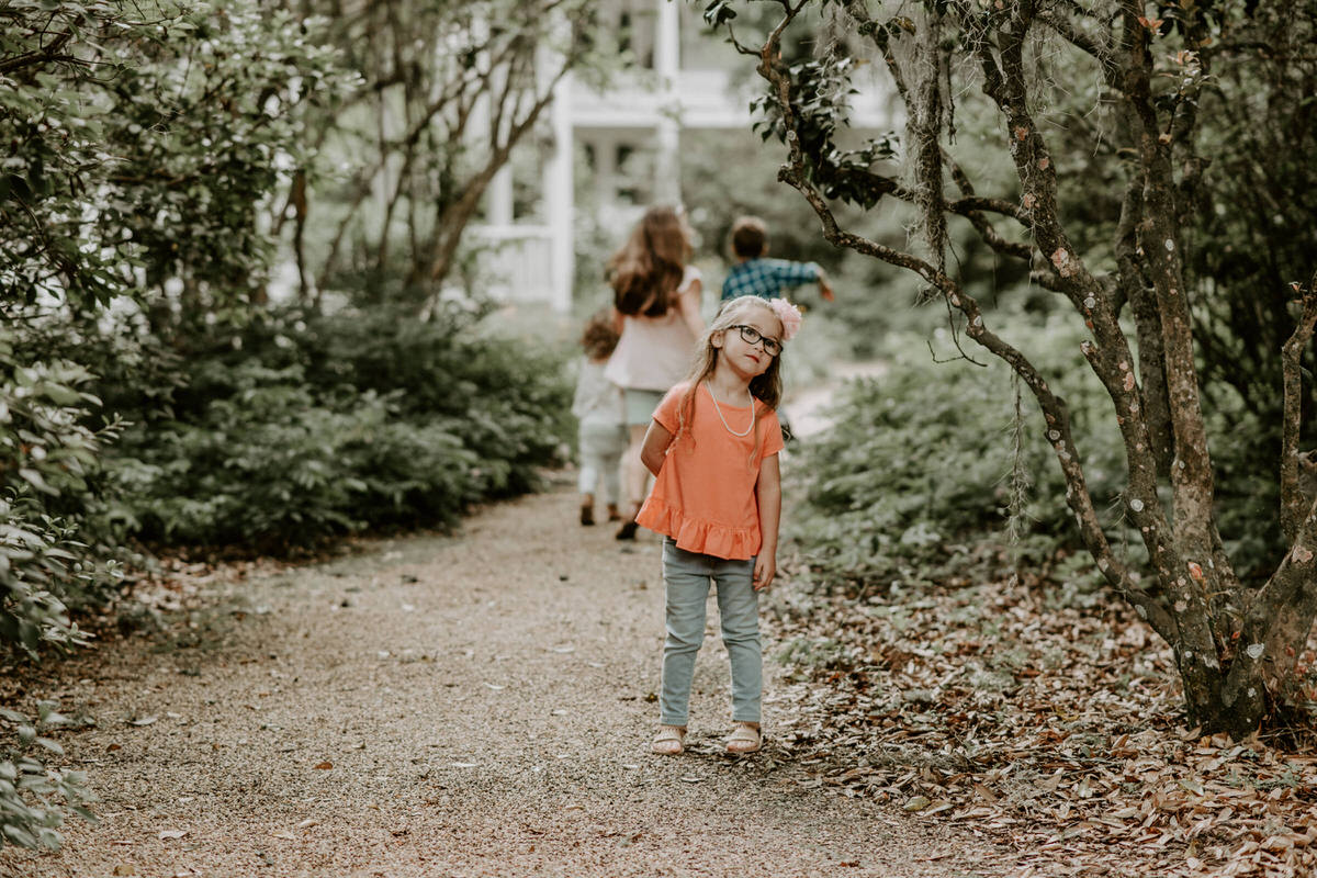 Sweet family and surprise proposal session in st. francisville, louisiana at rosedown plantation with gorgeous oak trees photographed by magnolia and grace photography