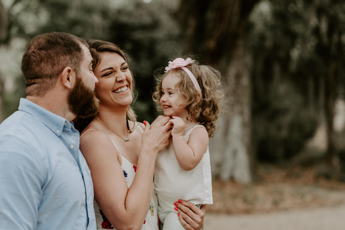 Sweet family and surprise proposal session in st. francisville, louisiana at rosedown plantation with gorgeous oak trees photographed by magnolia and grace photography