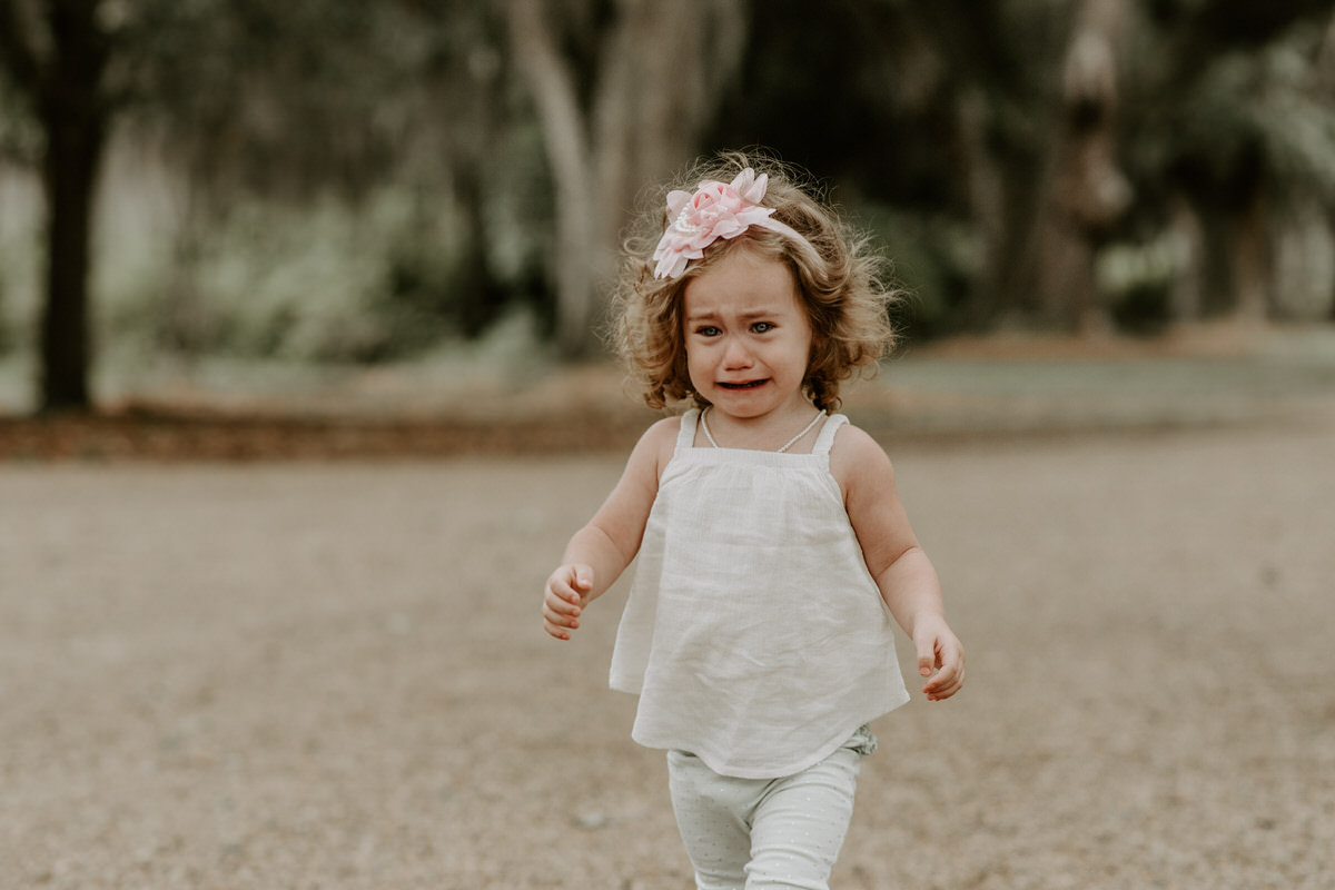 Sweet family and surprise proposal session in st. francisville, louisiana at rosedown plantation with gorgeous oak trees photographed by magnolia and grace photography