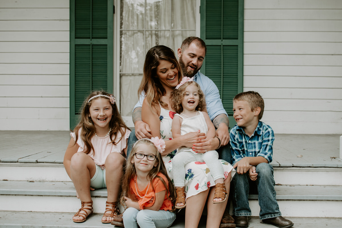 Sweet family and surprise proposal session in st. francisville, louisiana at rosedown plantation with gorgeous oak trees photographed by magnolia and grace photography