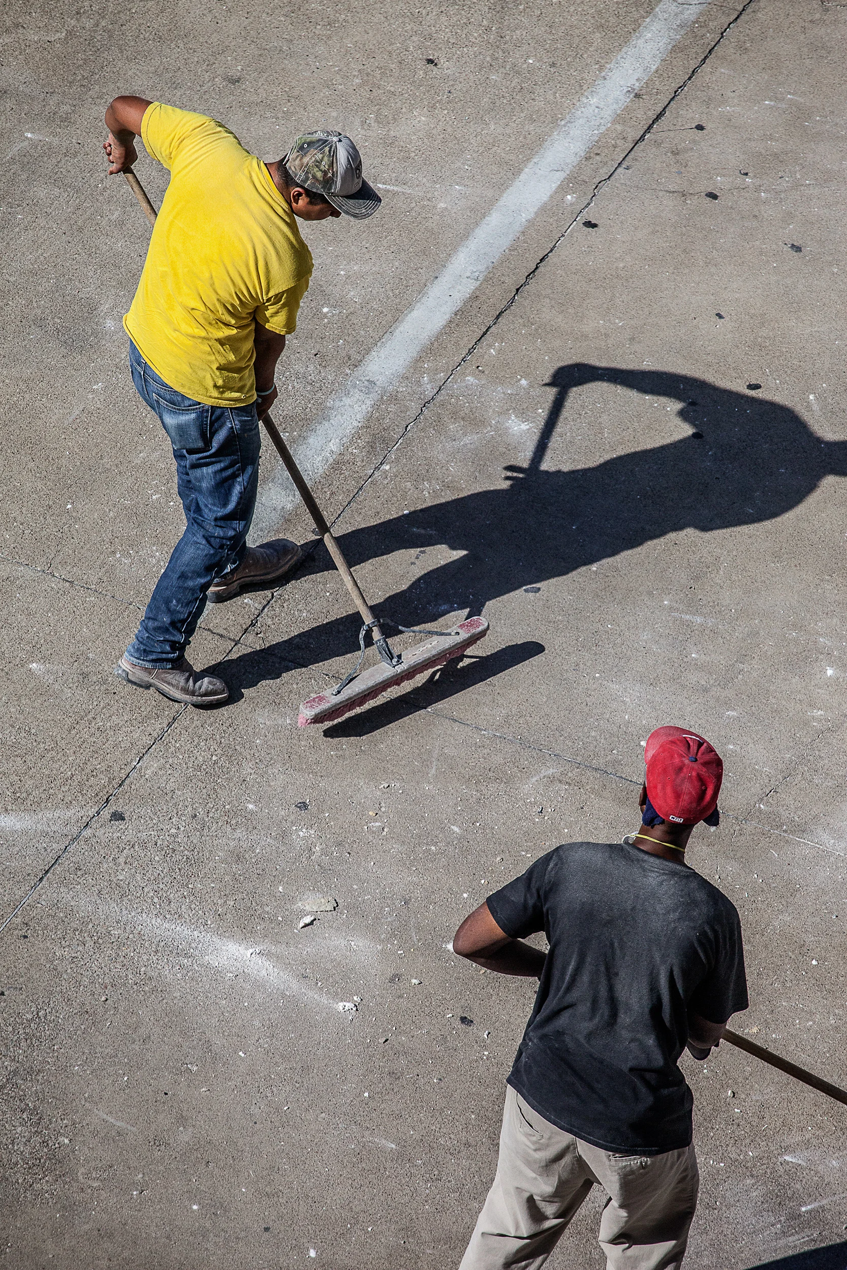 Men-In-Yellow-And-Red-Shirts-Sweeping-Driveway-Sharp-From-Studio-Window_100175.jpg