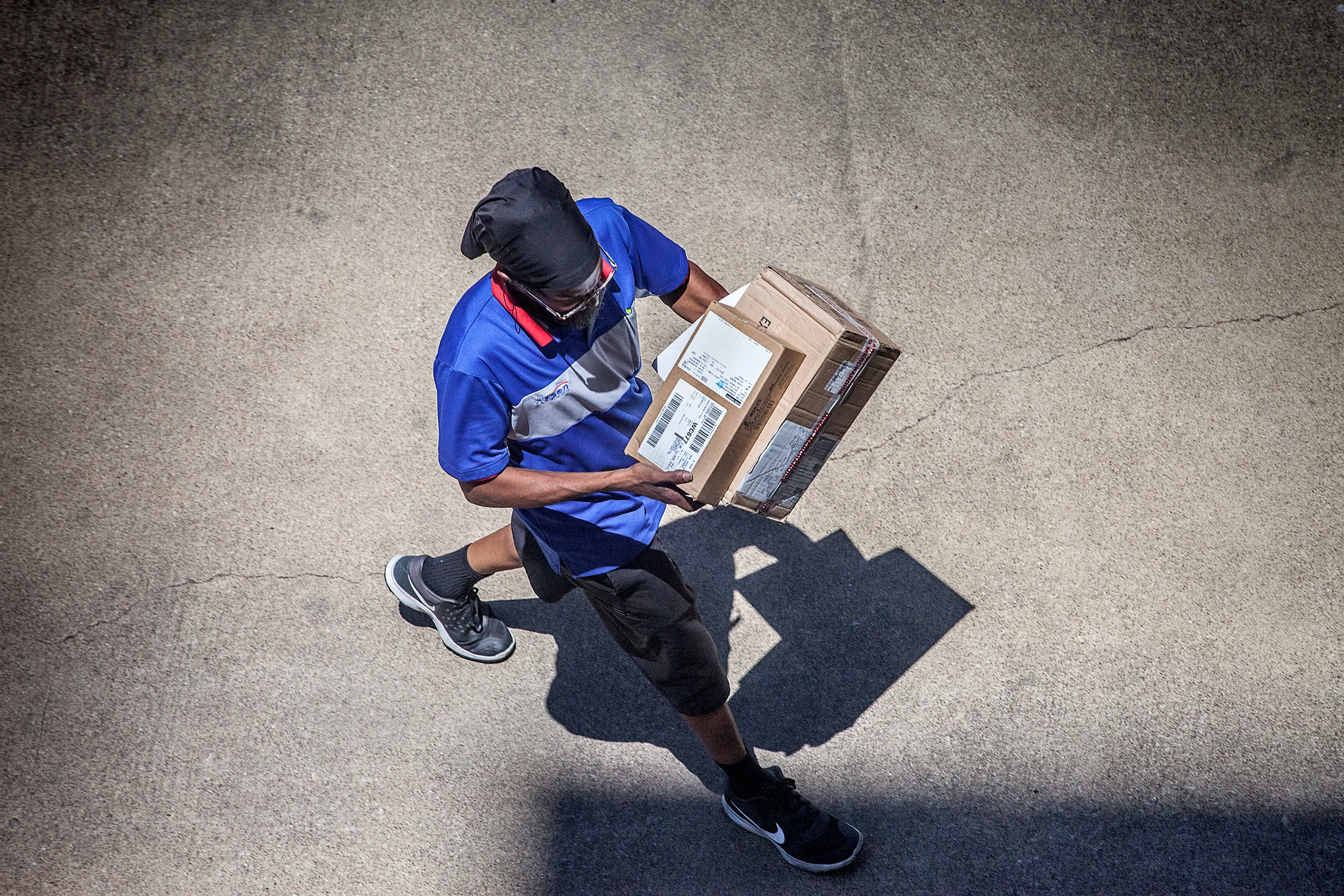 Rasta-Deliveryman-Carring-Boxes-W-Shadow-From-Studio-Window_97426.jpg