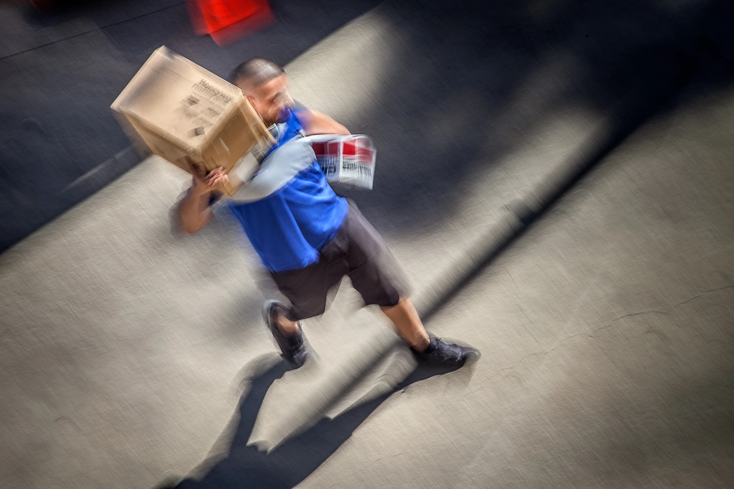 Man-W-Box-On-His-Shoulder-Near-Park-Garage-W-Shadows-From-Studio-Window_101009.jpg
