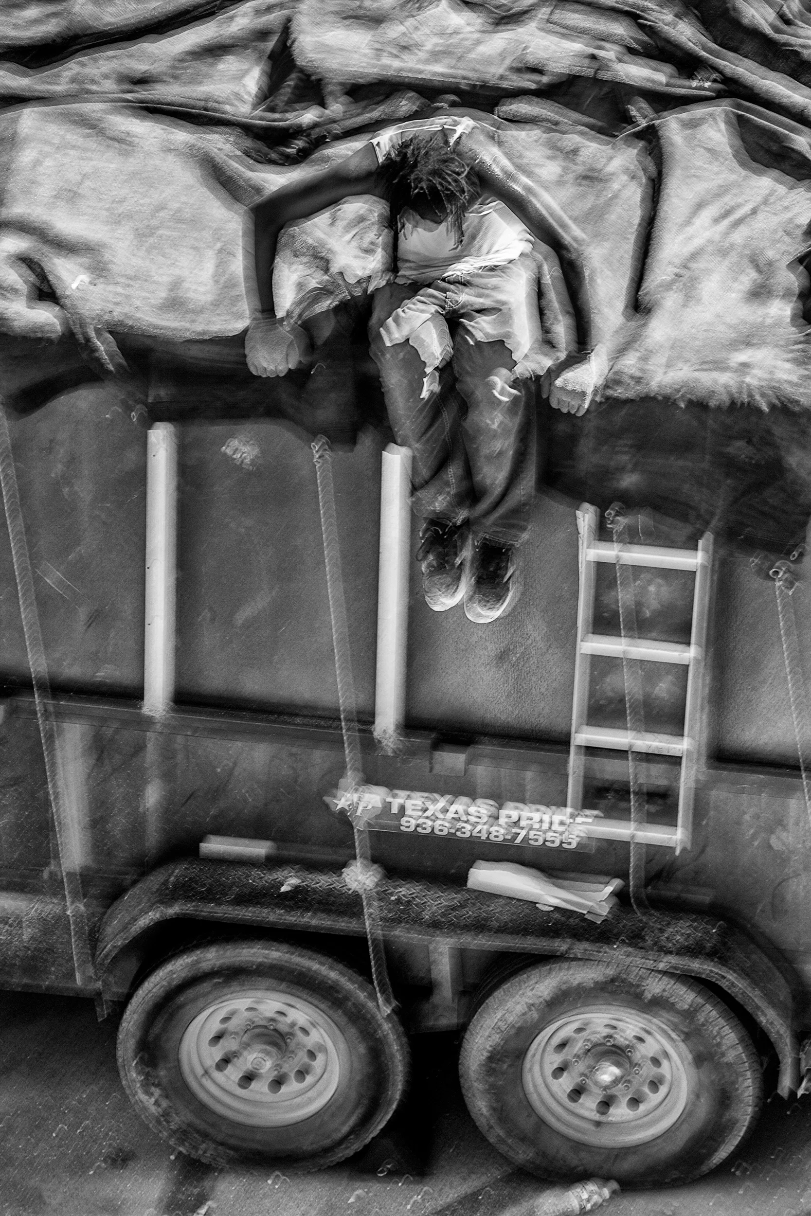 Man-In-Braids-Jumping-Down-From-Trailer-Dumpster-From-Studio-Window-BW_100078.jpg