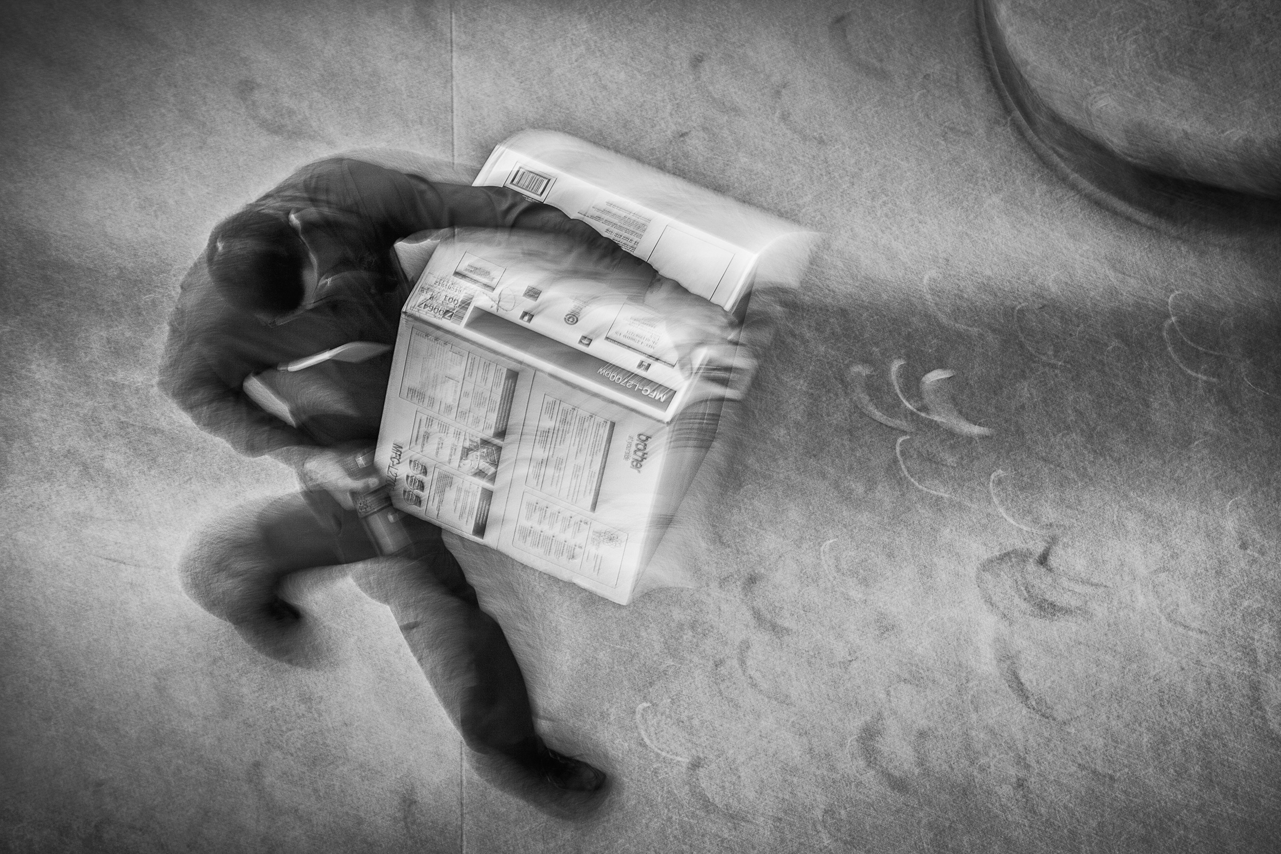 UPS-Driver-Carrying-Large-Box-In-Driveway-From-Studio-Window-BW_81900.jpg