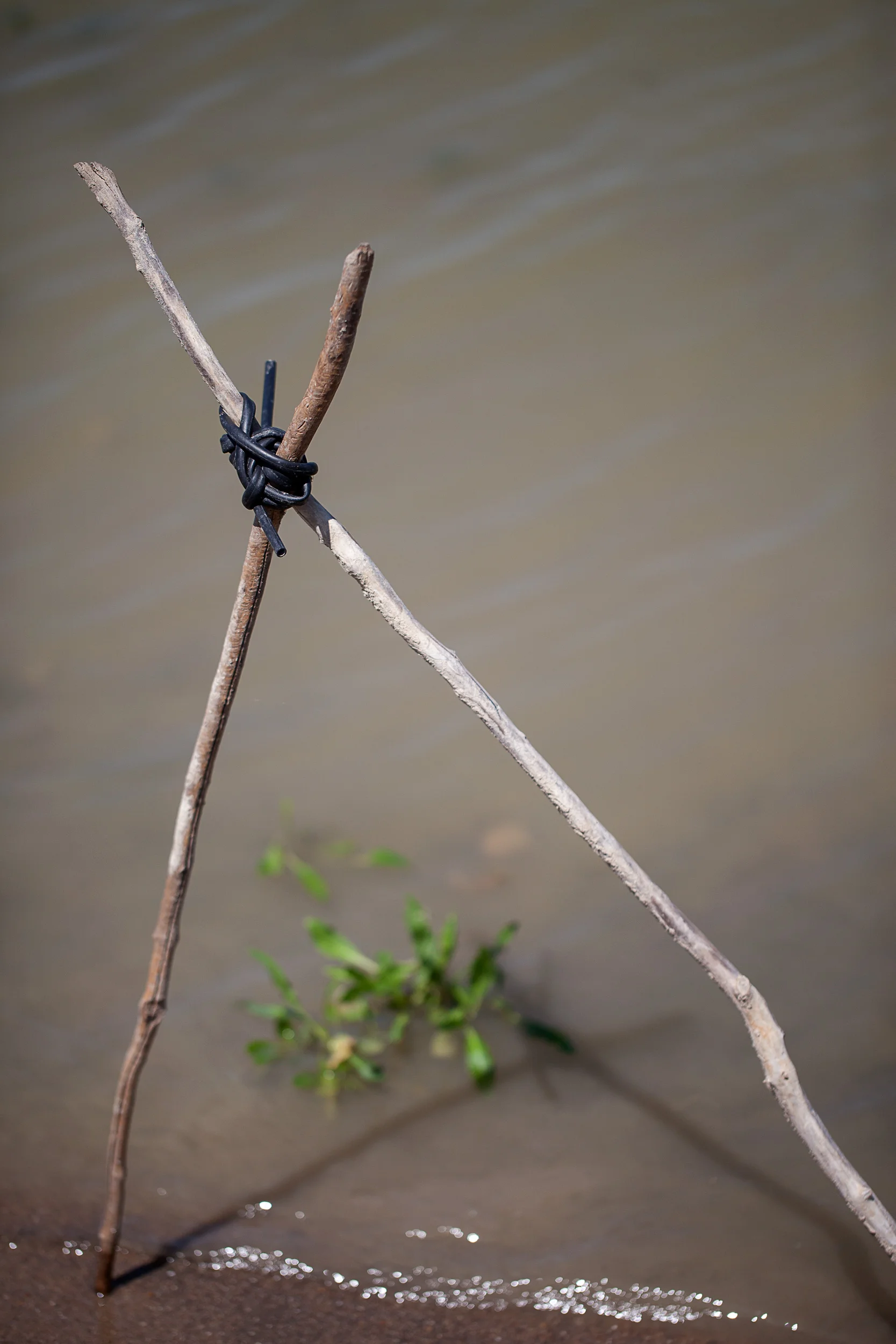 Two-Sticks-Lashed-W-Rubber-Tubing-On-Shoreline_27693.jpg