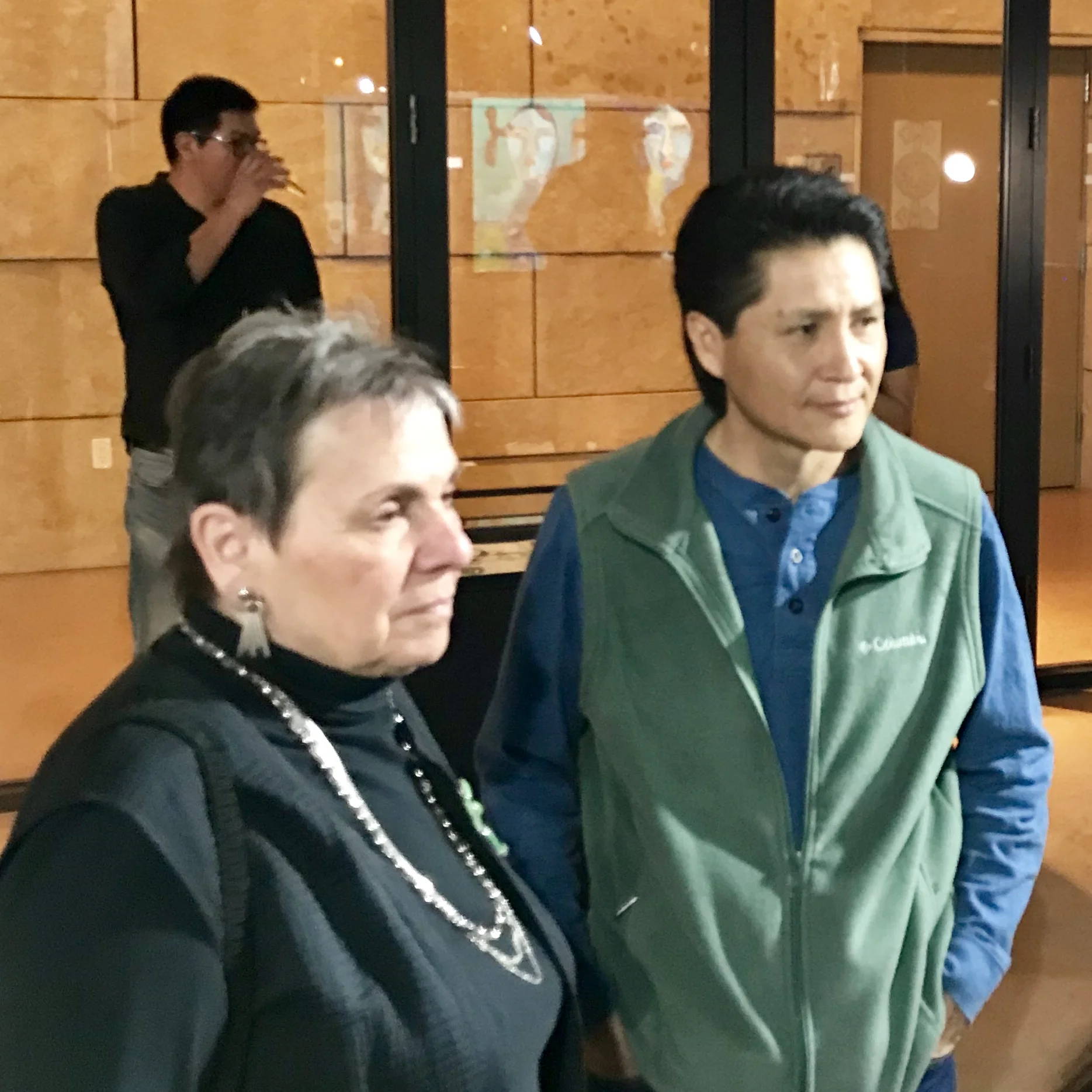 Artist Joe Cajero speaks with attendants of the show.