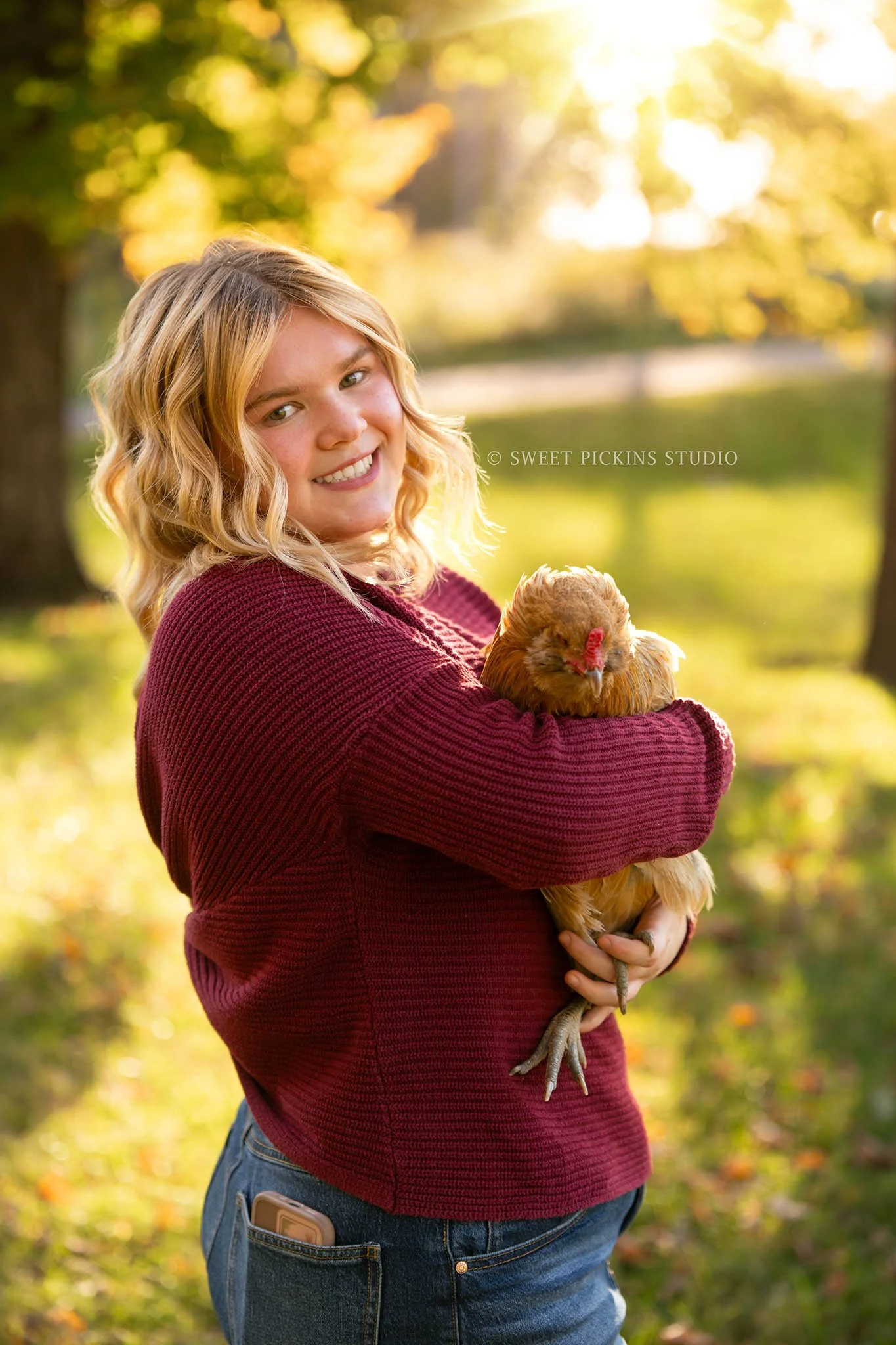 Rilynn’s Peru, Indiana Fall Senior Portrait Photography with pet chicken for Maconaquah High School class of 2027 senior girl wearing maroon sweater and denim skirt on plaid blanket by Sweet Pickins Studio senior photographer Amanda Wilson ©