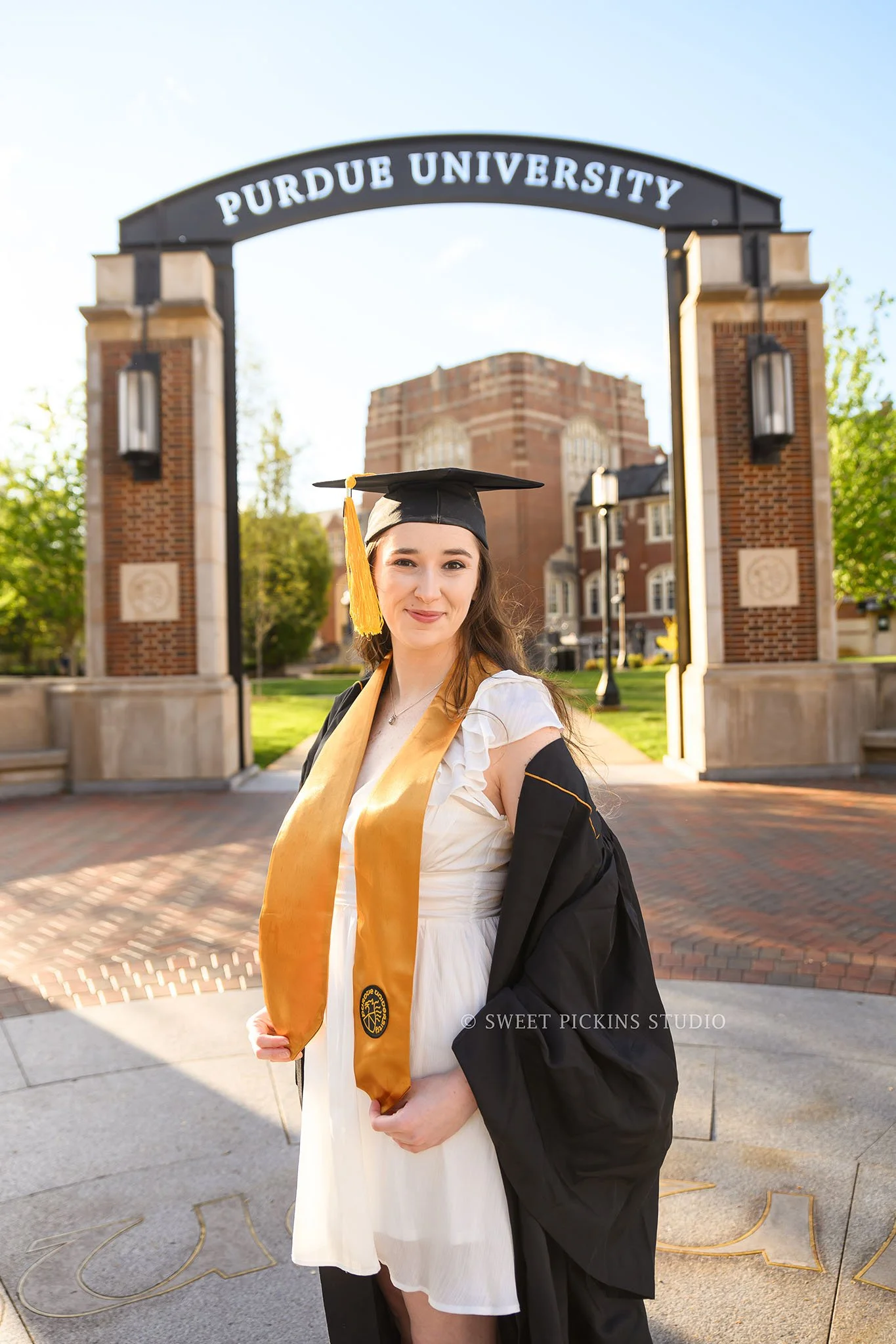 Emily | Purdue University Graduation Portrait Photography in Cap and Gown in West Lafayette, Indiana at Memorial Union Arch in Spring by Sweet Pickins Studio senior photographer Amanda Wilson ©