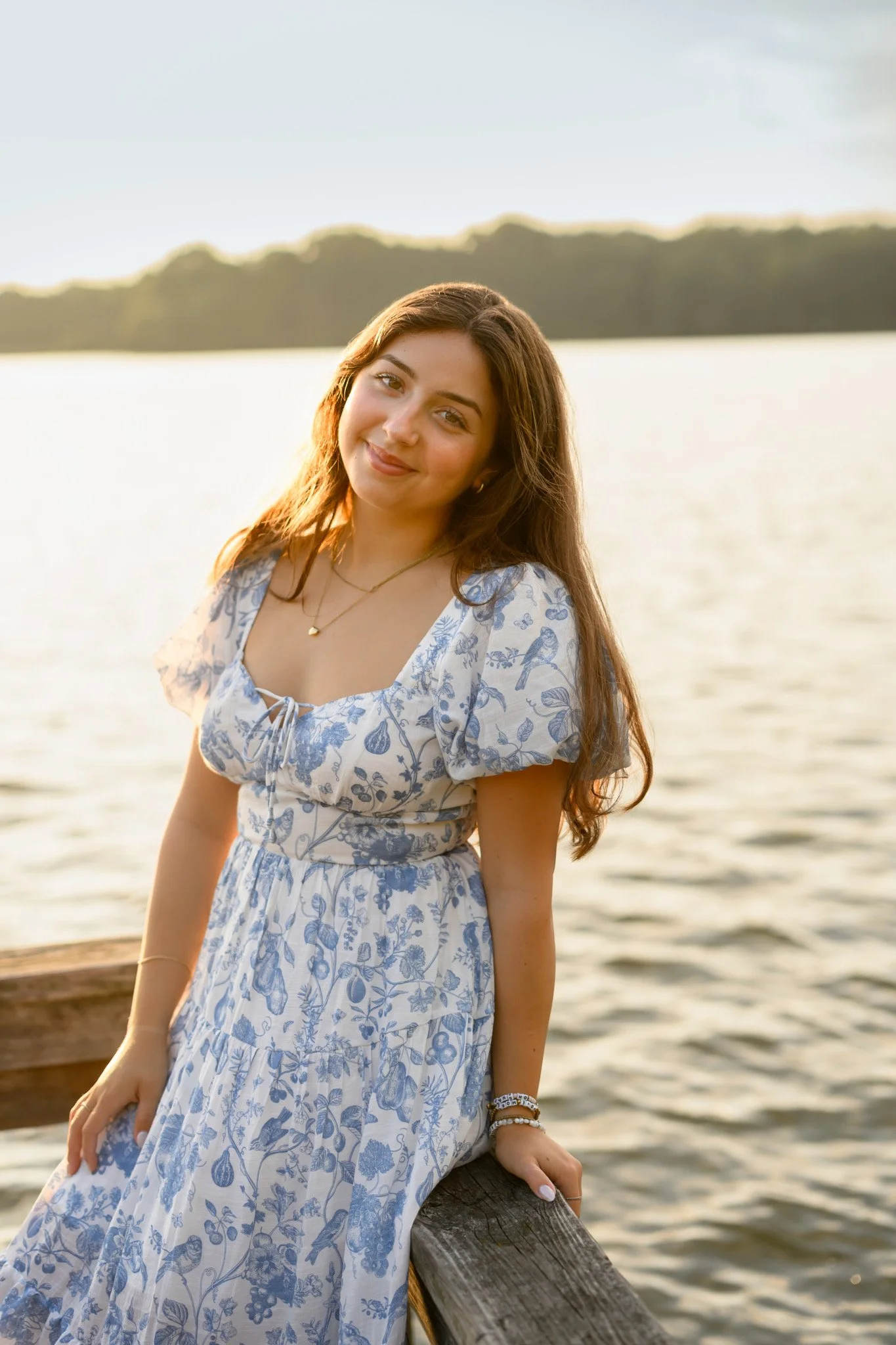 Maisie | Lakeville, Indiana Senior Pictures at the Lake for Madison East High School class of 2027 senior girl posing in floral dress on pier by Peru Indiana senior photographer Amanda Wilson © Sweet Pickins Studio