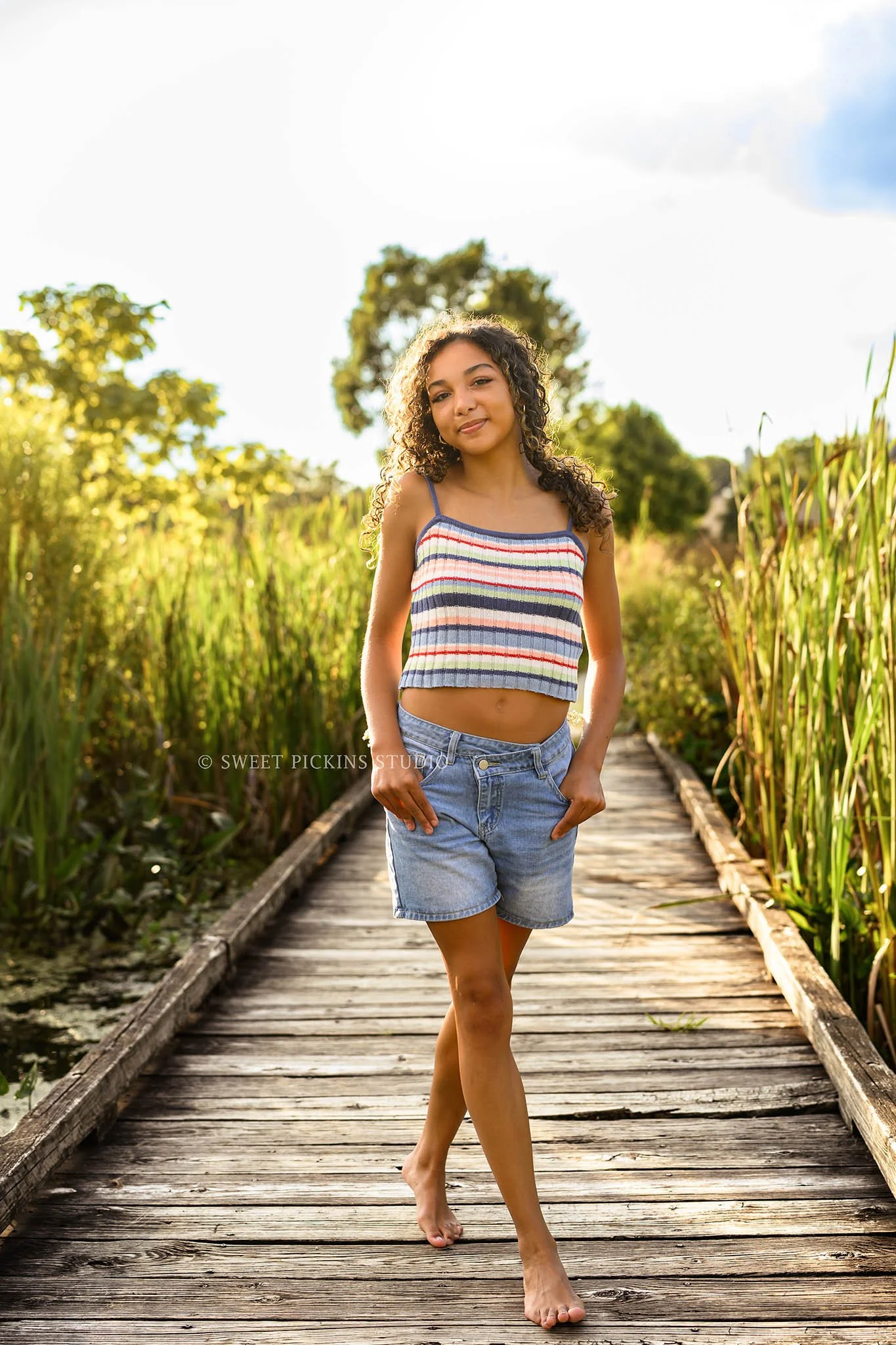 Madeline | Senior Girl Photography on Wood Boardwalk for Class of 2027 wearing colorful tank top and denim jean shorts by Peru Indiana Senior  photographer Amanda Wilson of Sweet Pickins Studio ©