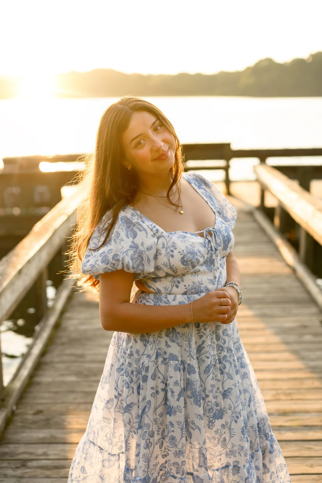 Maisie | Lakeville, Indiana Senior Portrait Photography at the Lake for Madison East High School class of 2027 senior girl posing in floral dress on pier by Peru Indiana senior photographer Amanda Wilson © Sweet Pickins Studio