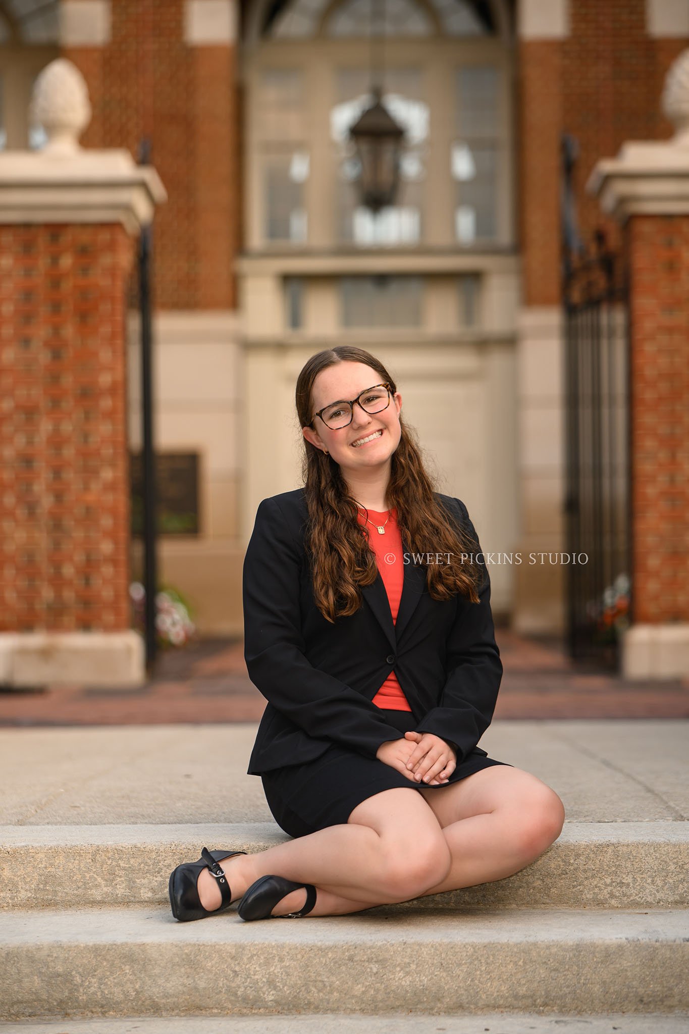 Downtown Carmel, Indiana Senior Photography for Class of 2027 Senior Ellen at City Hall wearing business suit in summer by Sweet Pickins Studio senior photographer Amanda Wilson ©