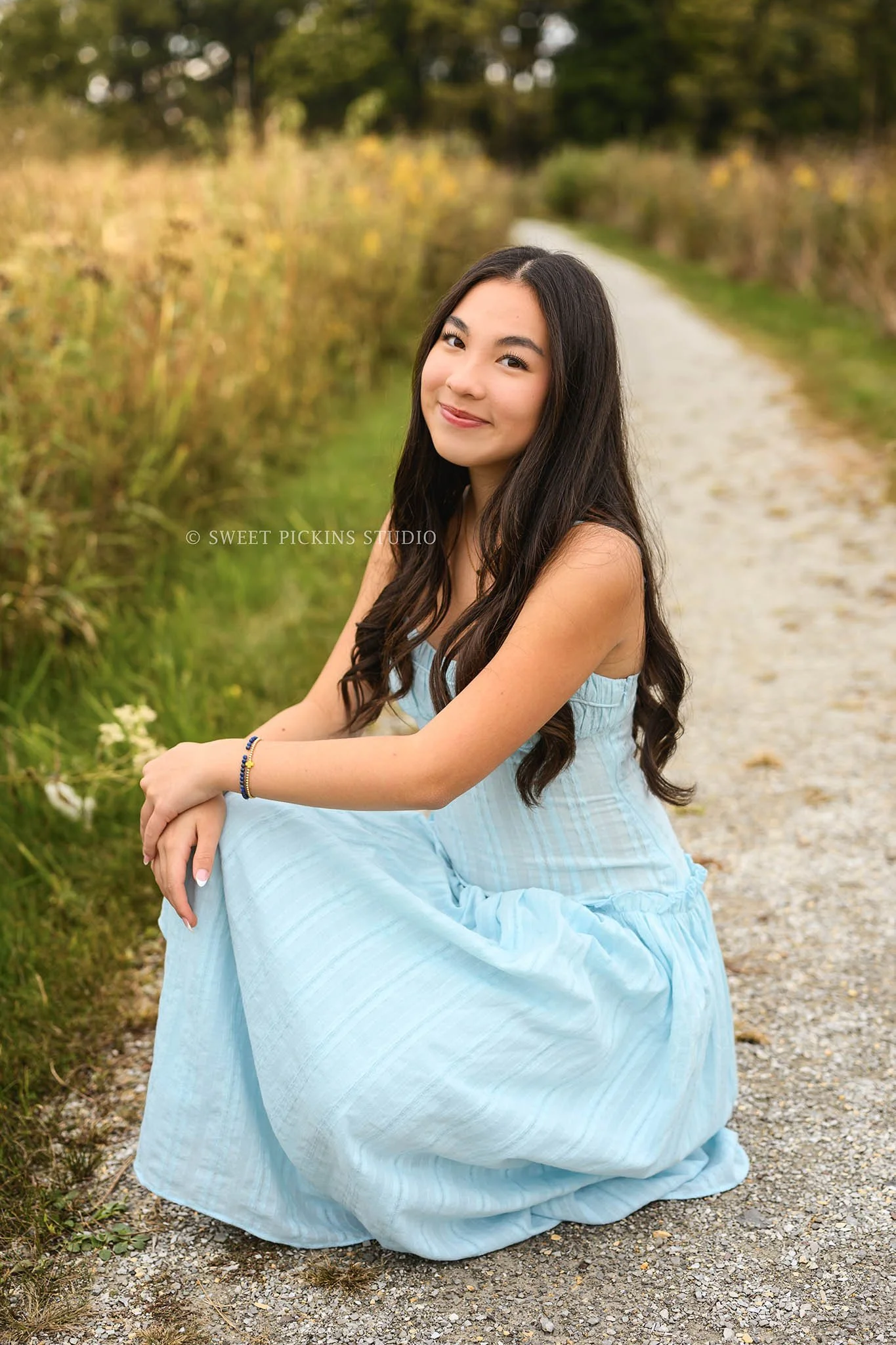 Nora | Carmel, Indiana Senior Girl Pictures posing on nature path in golden grass wearing blue dress for Park Tudor Class of 2027 by Sweet Pickins Studio senior photographer Amanda Wilson ©