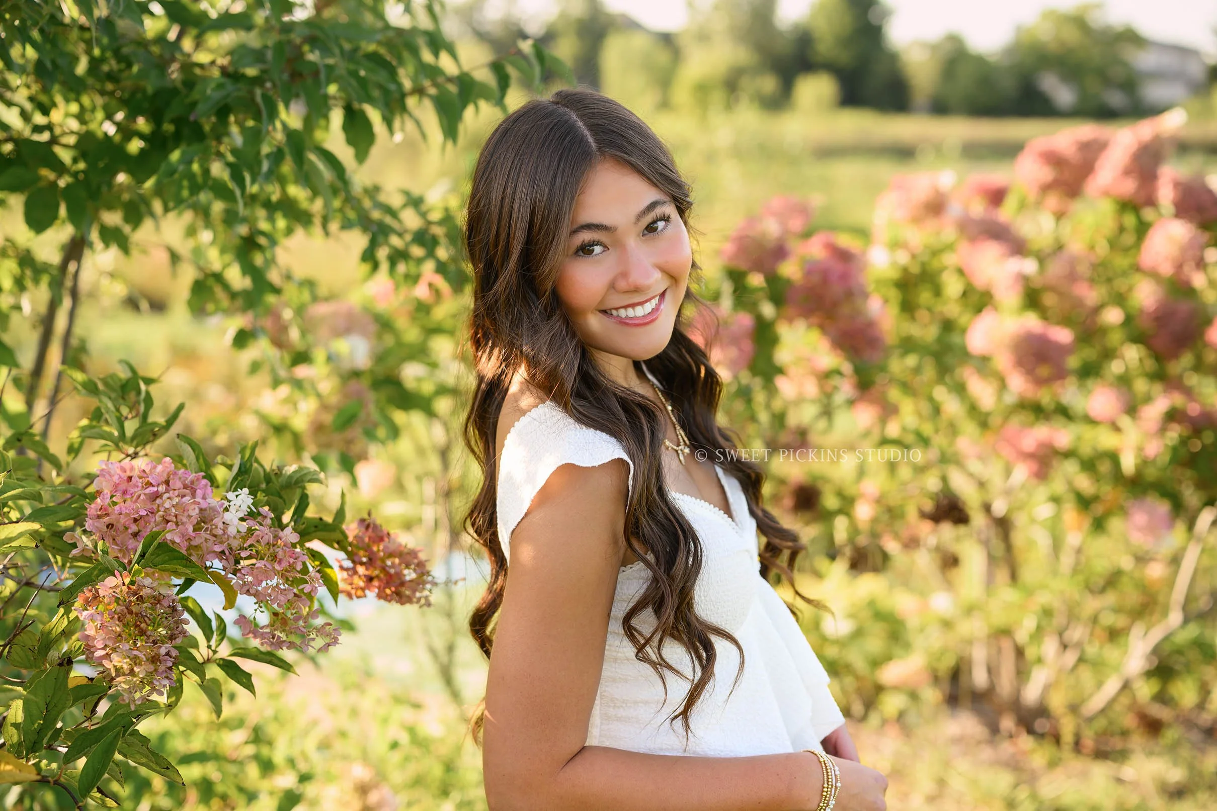 Rachel | Carmel, Indiana Floral Senior Portraits by Pink Hydrangea flowers for Class of 2027 senior girl posing in denim jeans and white shirt by Sweet Pickins Studio senior photographer Amanda Wilson ©