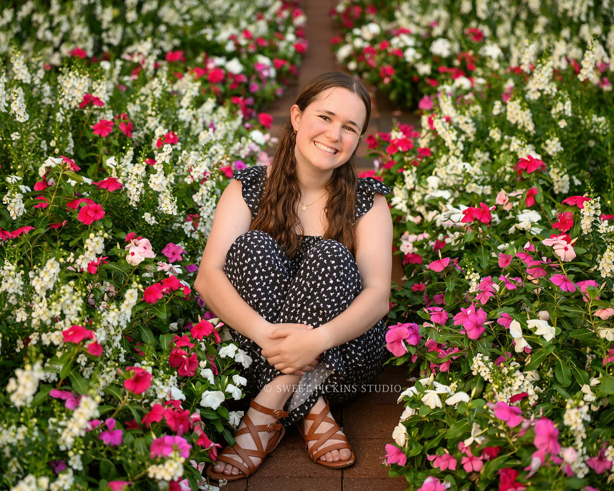 Downtown Carmel, Indiana Senior Photography for Class of 2027 Senior Ellen at city hall with flowers wearing floral romper by Sweet Pickins Studio senior photographer Amanda Wilson ©