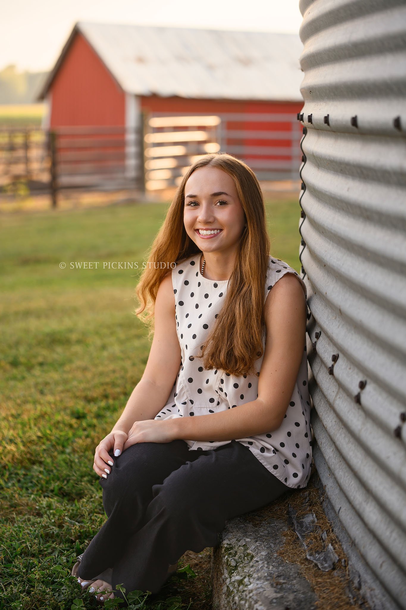 Natalie’s Lowell, Indiana Farm Senior Photography for class of 2027 senior girl posing by grain bin and red cattle barn at farm by Sweet Pickins Studio senior photographer Amanda Wilson ©
