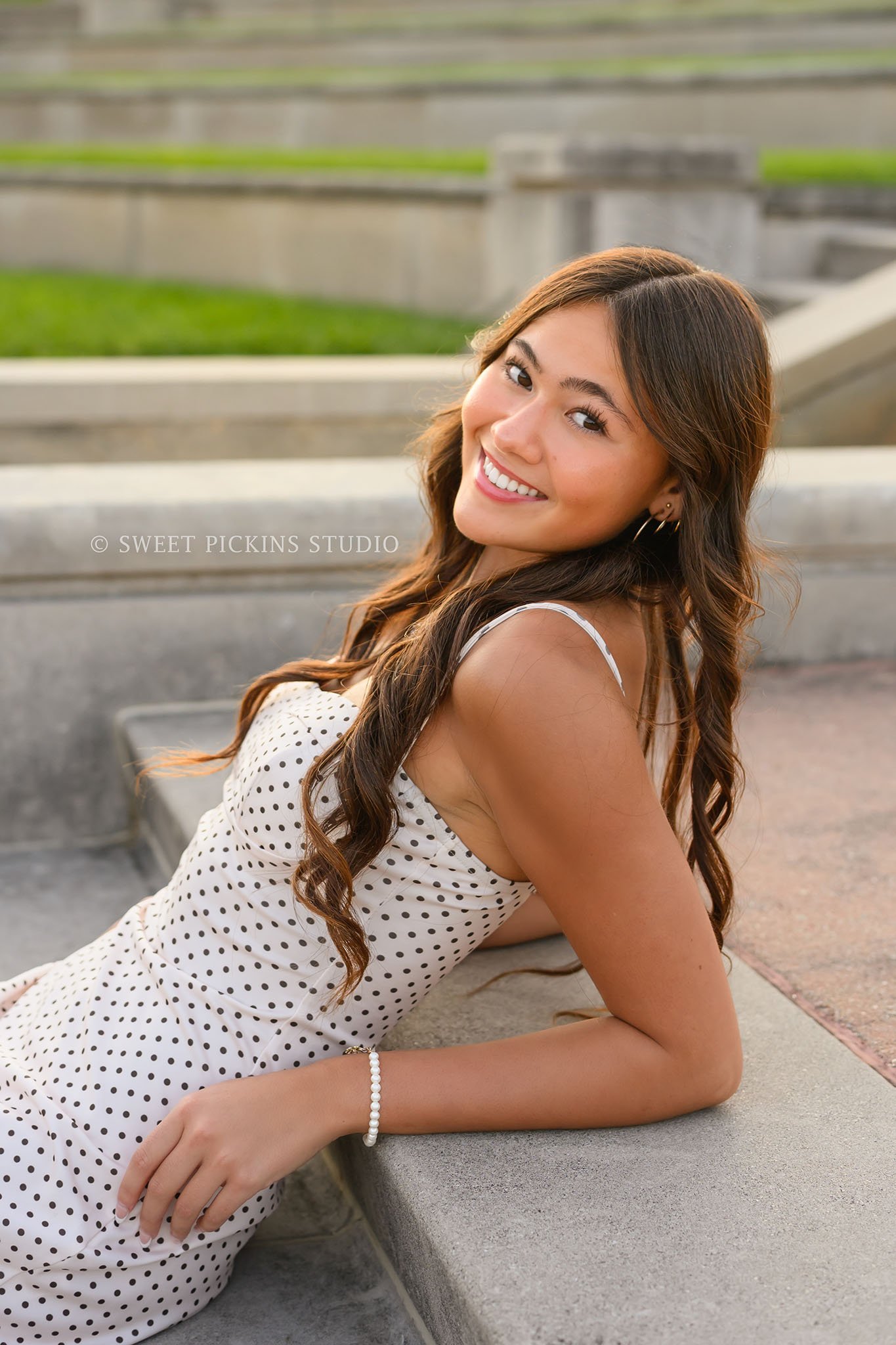 Rachel | Carmel, Indiana Senior Photography for Class of 2027 senior girl posing on steps in polka dot summer dress by Sweet Pickins Studio senior photographer Amanda Wilson ©