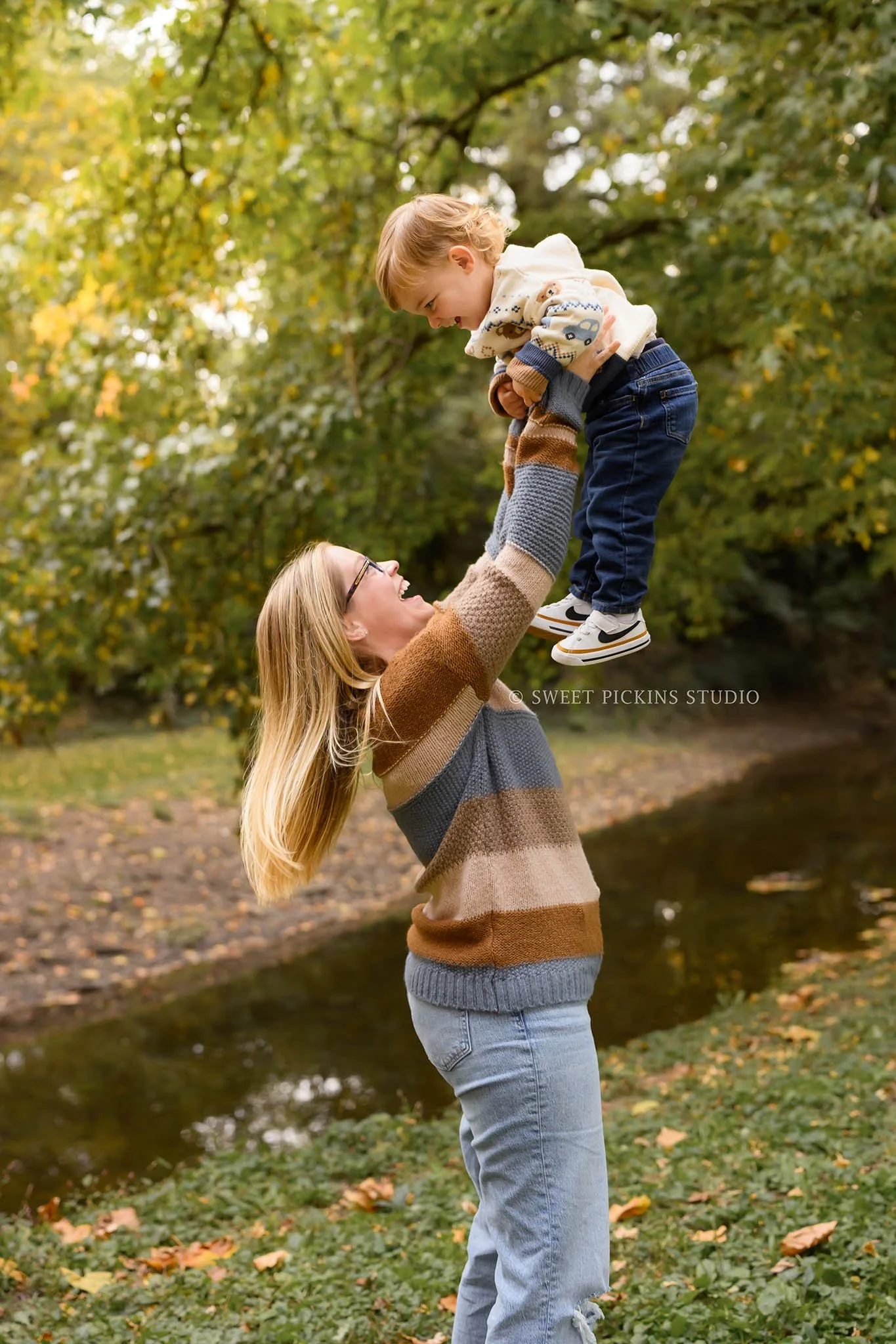Kokomo, Indiana Fall Family Photography at Highland Park for Mommy and Son in autumn leaves by creek by Sweet Pickins Studio photographer Amanda Wilson ©