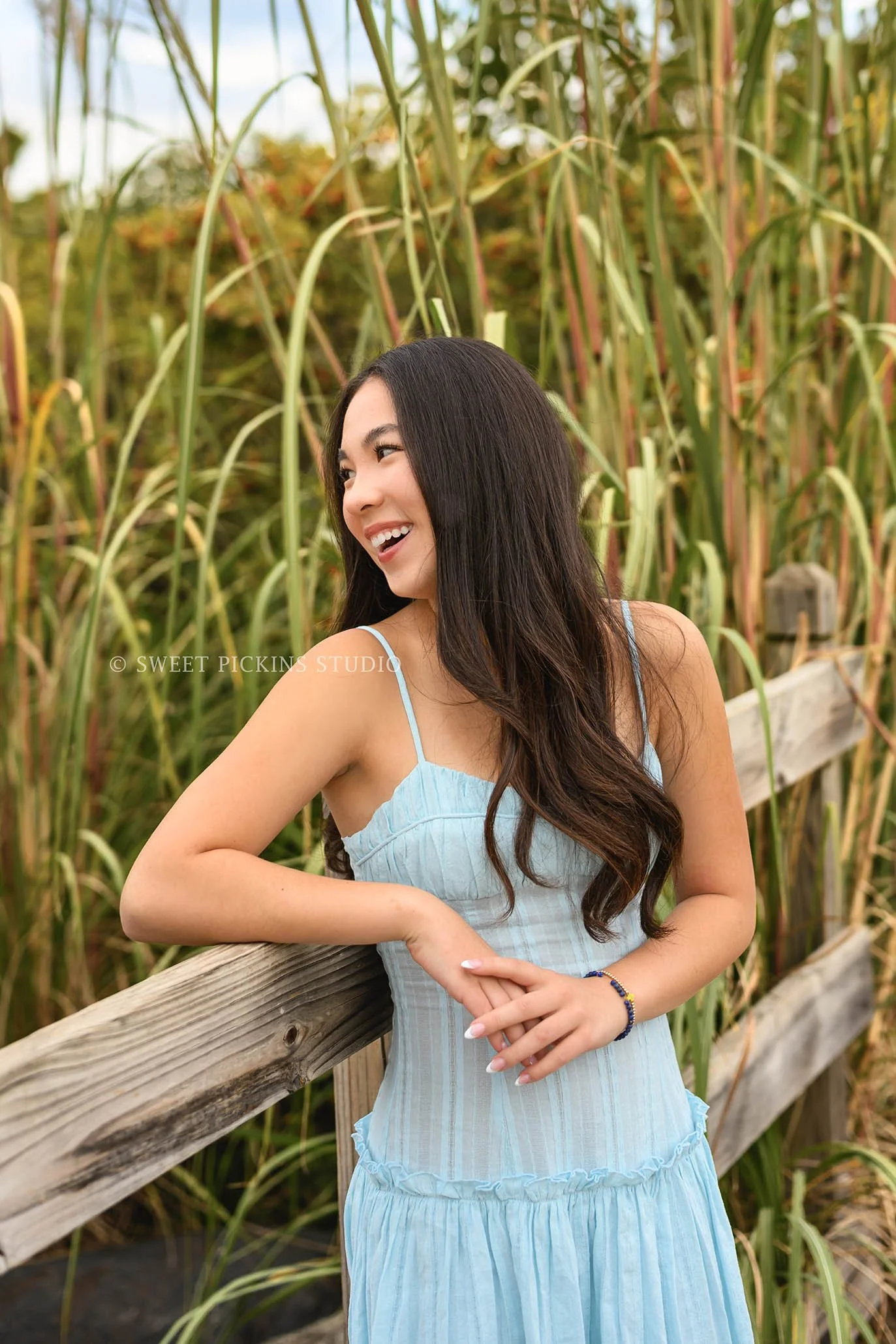 Nora | Carmel, Indiana Senior Girl Portraits posing on bridge wearing blue dress for Park Tudor Class of 2027 by Sweet Pickins Studio senior photographer Amanda Wilson ©