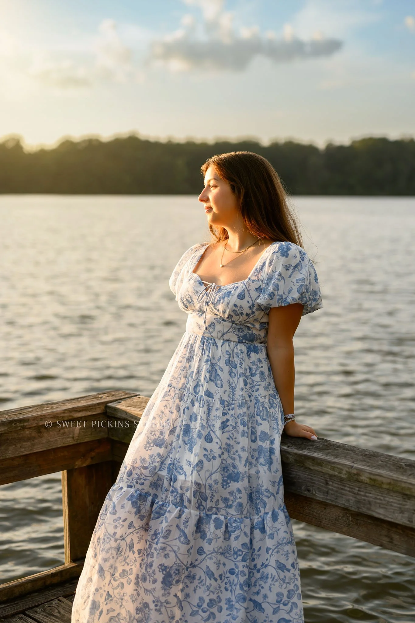 Maisie | Lakeville, Indiana Senior Portrait Photography at the Lake for Madison East High School class of 2027 senior girl posing in floral dress on pier by Peru Indiana senior photographer Amanda Wilson © Sweet Pickins Studio