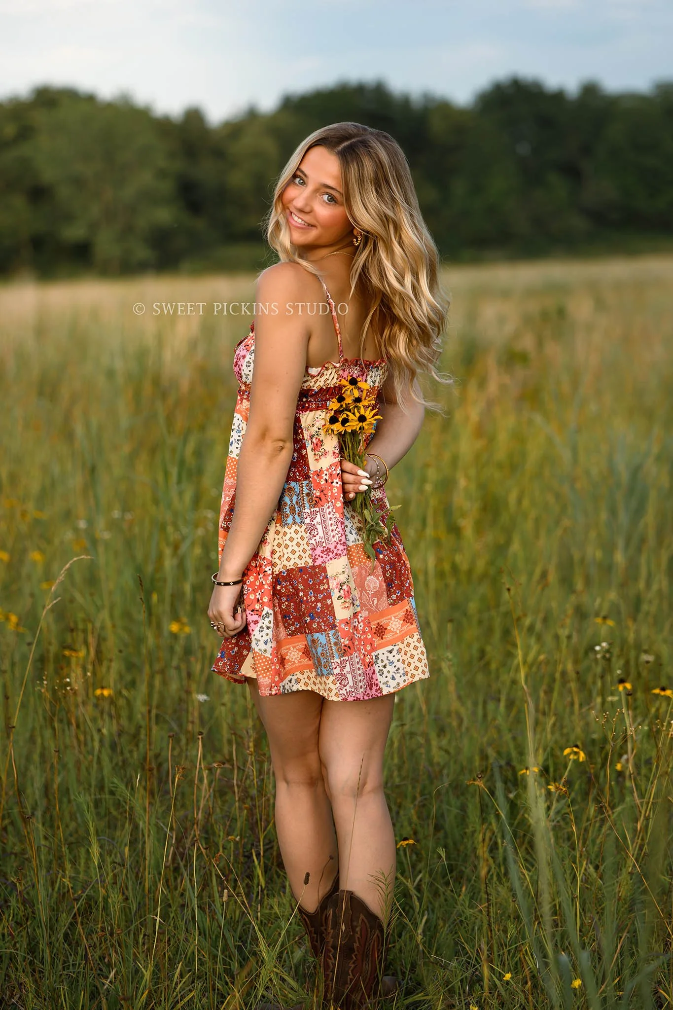 Addison’s Peru, Indiana Senior Photography in Wildflower Field at Sunset wearing patchwork babydoll dress with western cowboy boots in country location by Sweet Pickins Studio senior photographer Amanda Wilson  ©