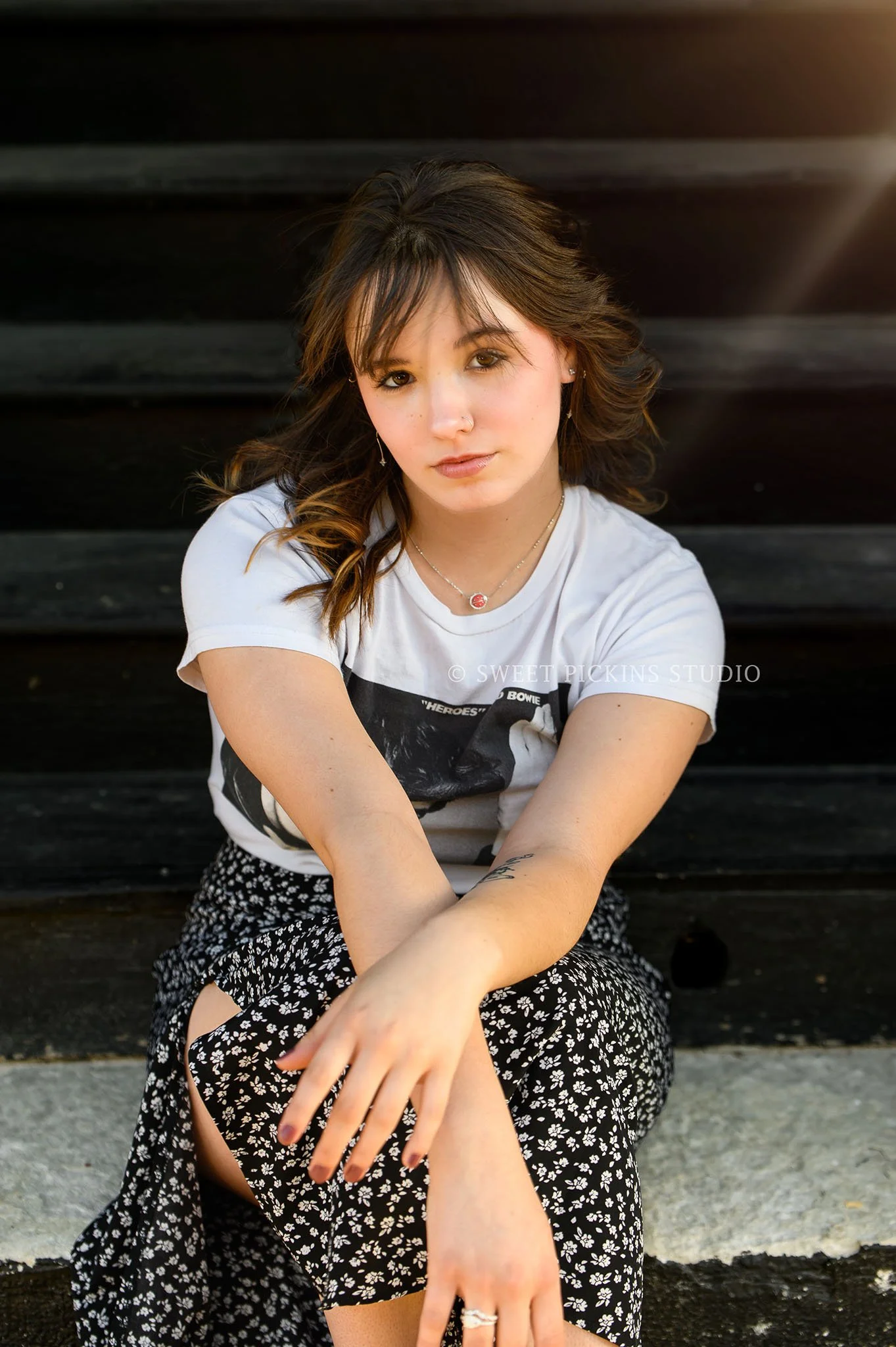 Hailee | Noblesville, Indiana Senior Portrait Photography in Urban Downtown for Noblesville High School class of 2026 senior girl posing on black stair steps in graphic tee and skirt by Sweet Pickins Studio senior photographer Amanda Wilson © 2026
