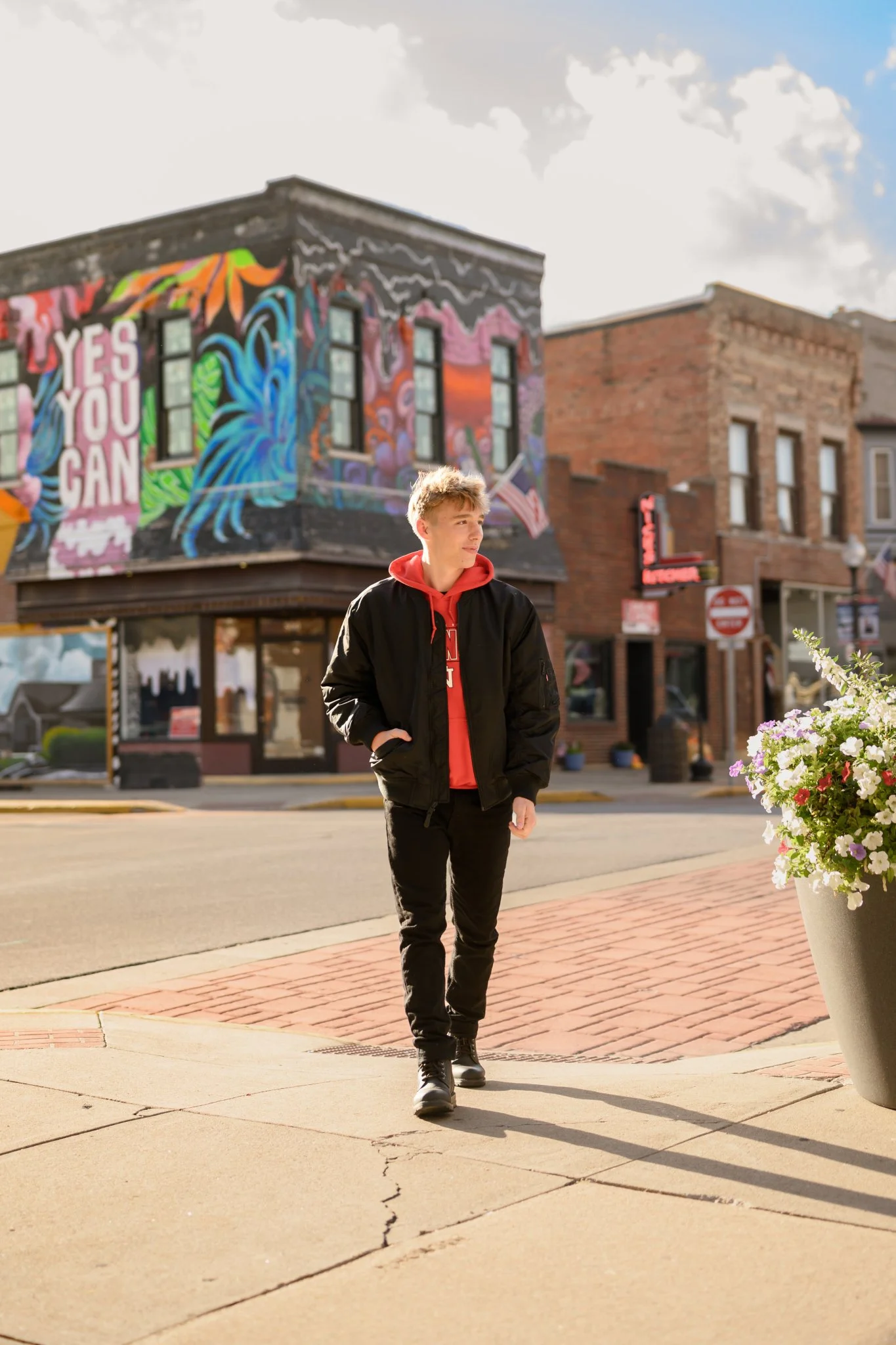 Huntington, Indiana Urban Senior Guy Photography for Huntington North Class of 2027 Senior  BOSTAN walking in urban downtown streets wearing black jacket and hoodie by Sweet Pickins Studio senior photographer Amanda Wilson ©