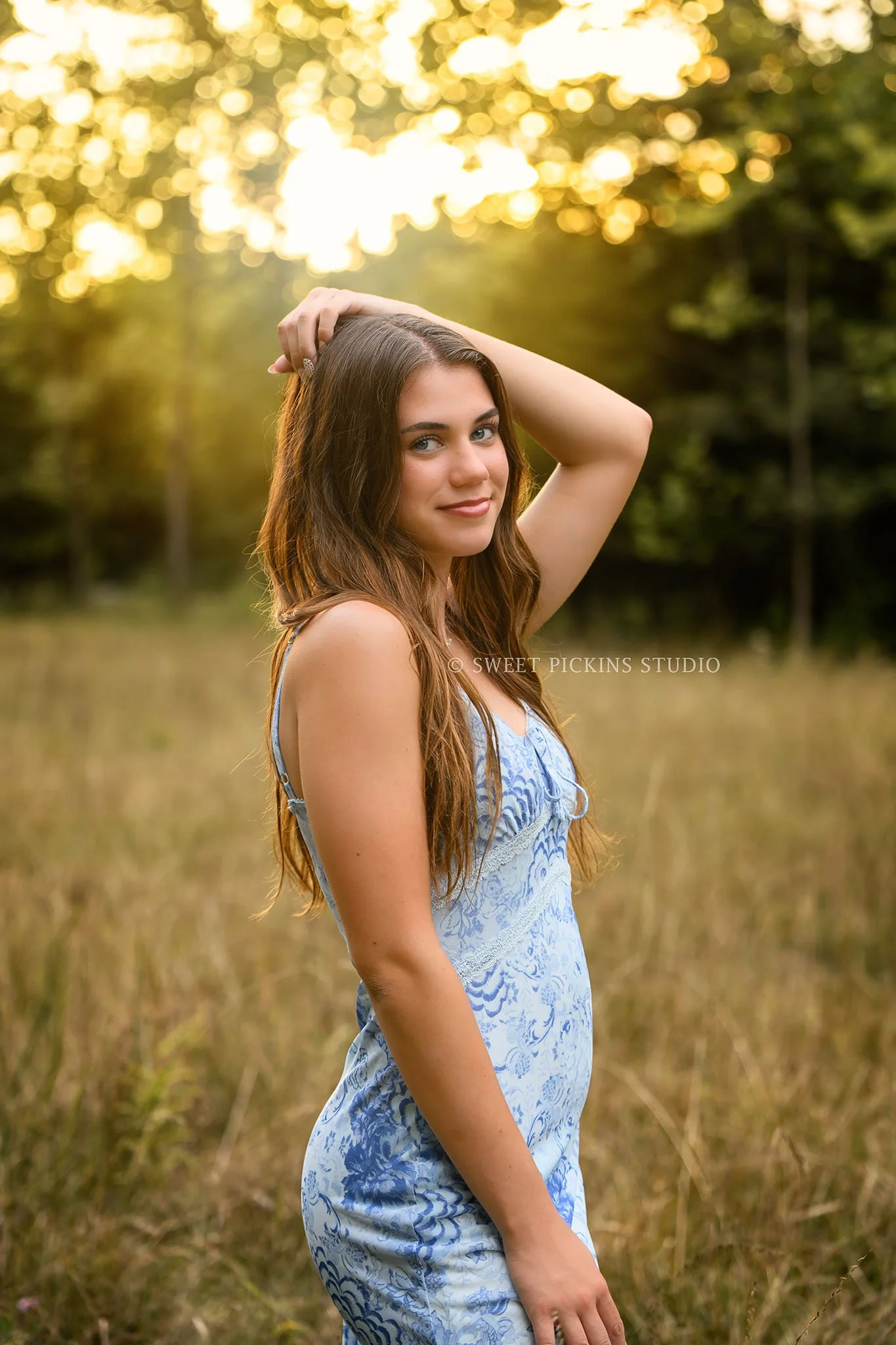 Taylor | Indiana Senior Girl Photography for class of 2027 senior in nature field in golden hour wearing blue floral dress by Sweet Pickins Studio senior photographer Amanda Wilson ©