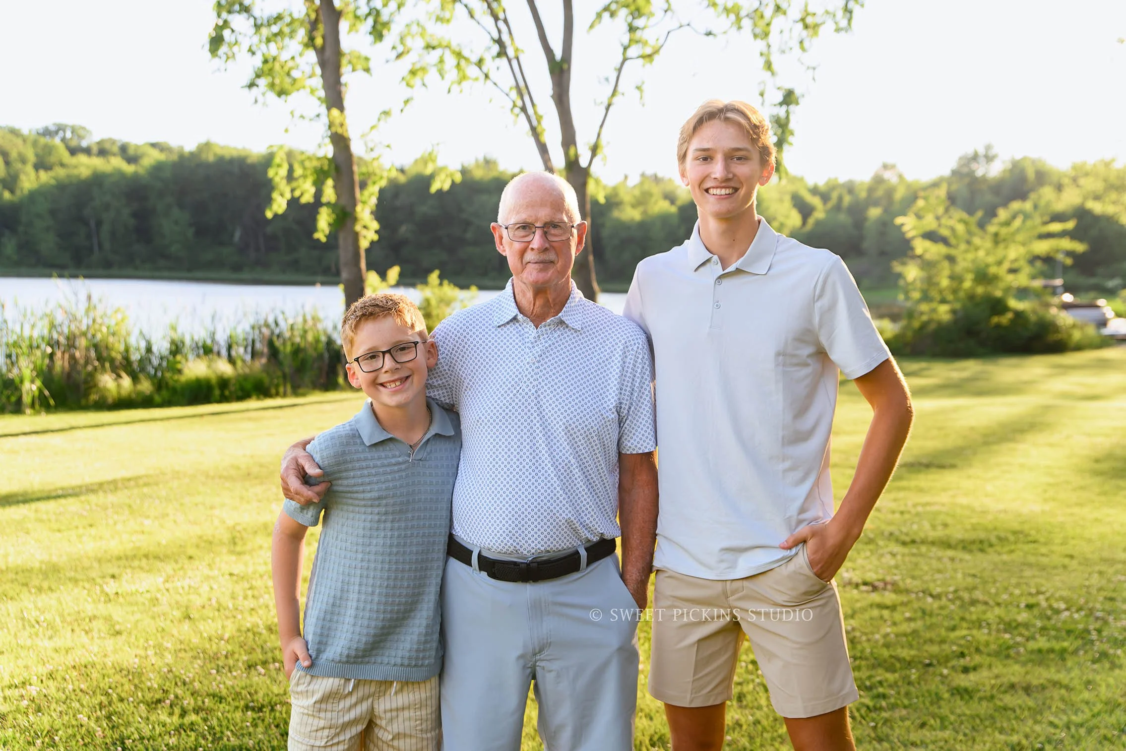 Roann, Indiana Grandparent Photography of grandfather with grandsons wearing blue and beige outfits at Luken’s Lake outdoor nature location in summer by Sweet Pickins Studio family photographer Amanda Wilson ©
