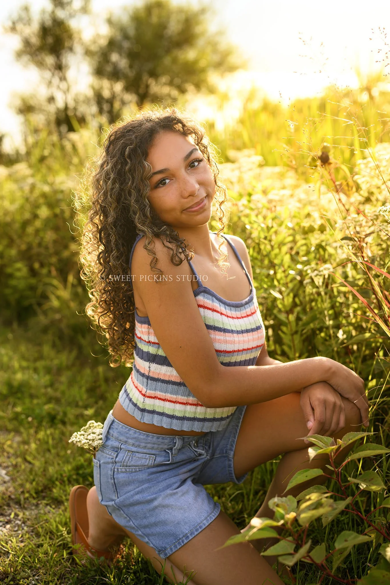 Madeline | Senior Girl Photography on Wood Boardwalk for Class of 2027 wearing colorful tank top and denim jean shorts by Peru Indiana Senior  photographer Amanda Wilson of Sweet Pickins Studio ©