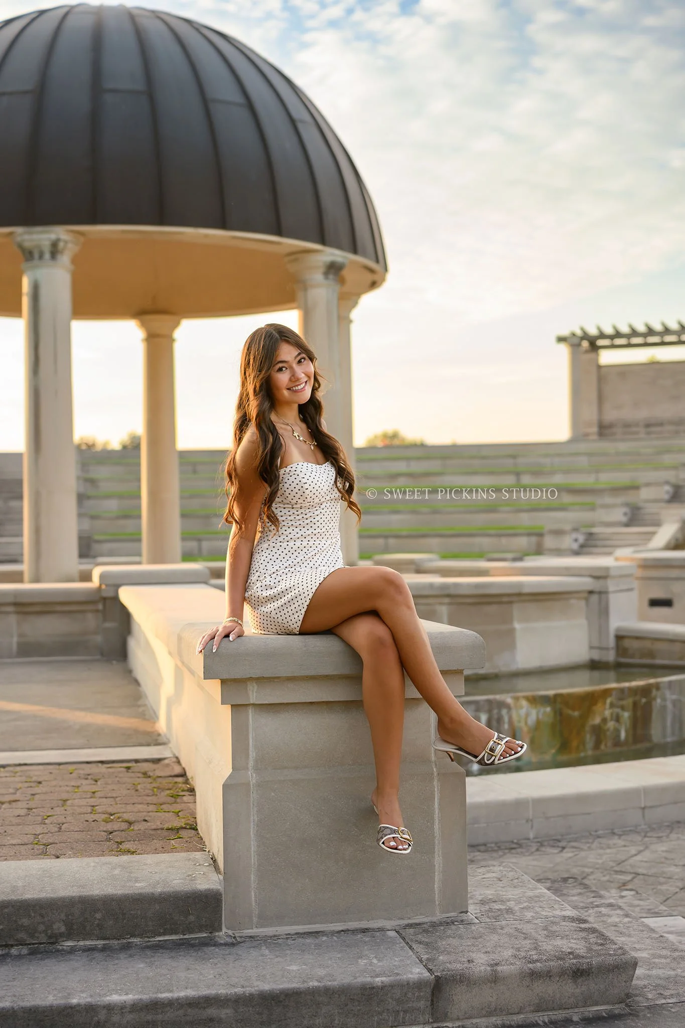 Rachel | Carmel, Indiana Senior Photography for Class of 2027 senior girl posing on steps in polka dot summer dress by Sweet Pickins Studio senior photographer Amanda Wilson ©