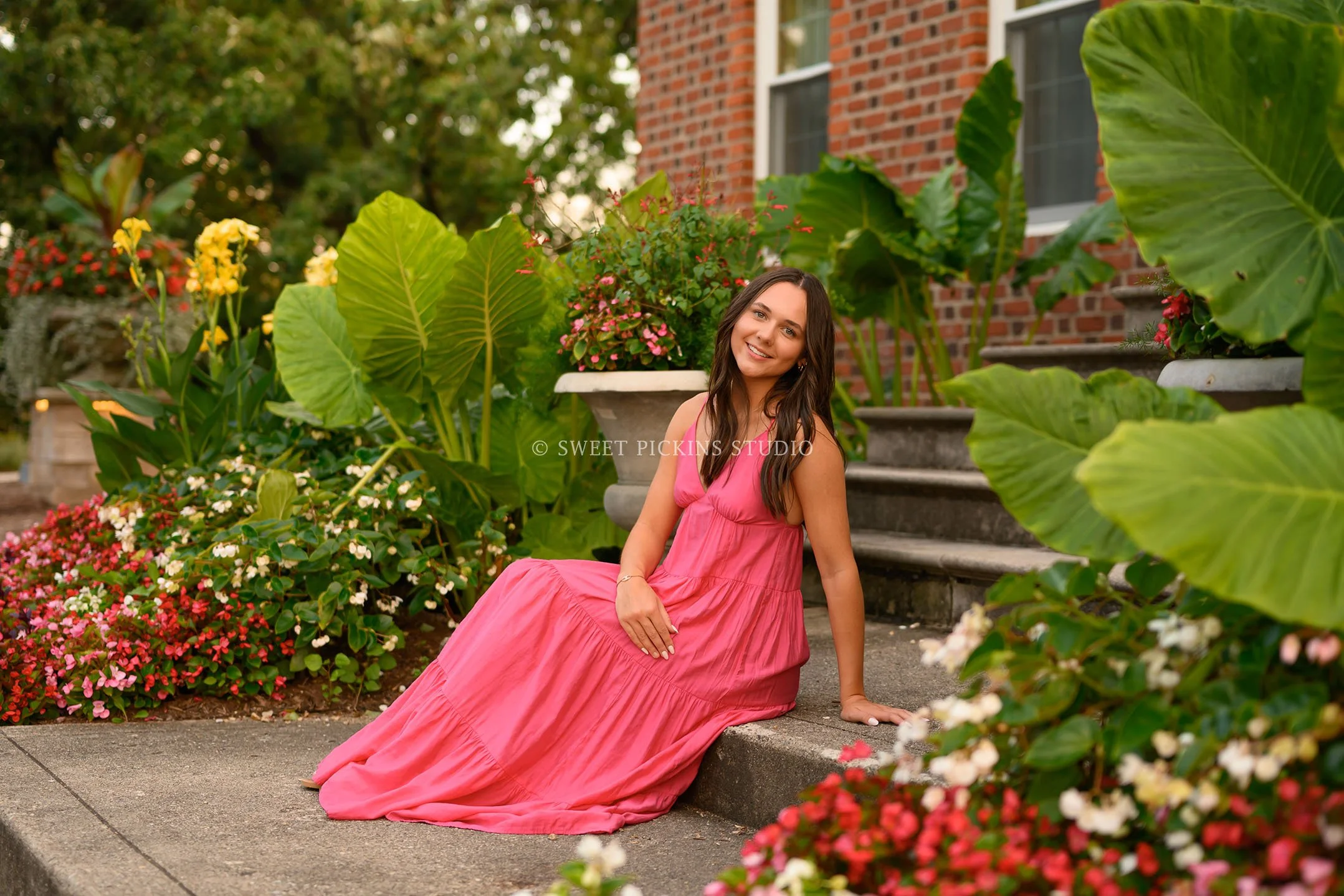 Sophie’s Carmel, Indiana Senior Photography by Sweet Pickins Studio senior photographer Amanda Wilson for class of 2027 Senior girl posing in pink maxi dress in flowers ©