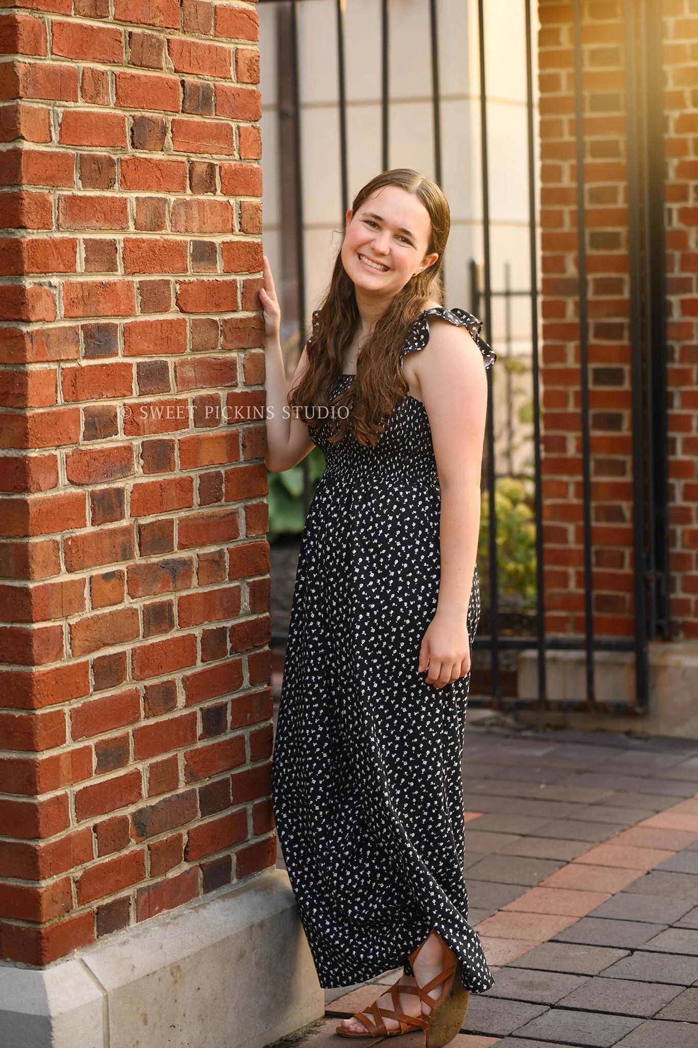 Downtown Carmel, Indiana Senior Photography for Class of 2027 Senior Ellen at city hall wearing floral romper in summer by Sweet Pickins Studio senior photographer Amanda Wilson ©