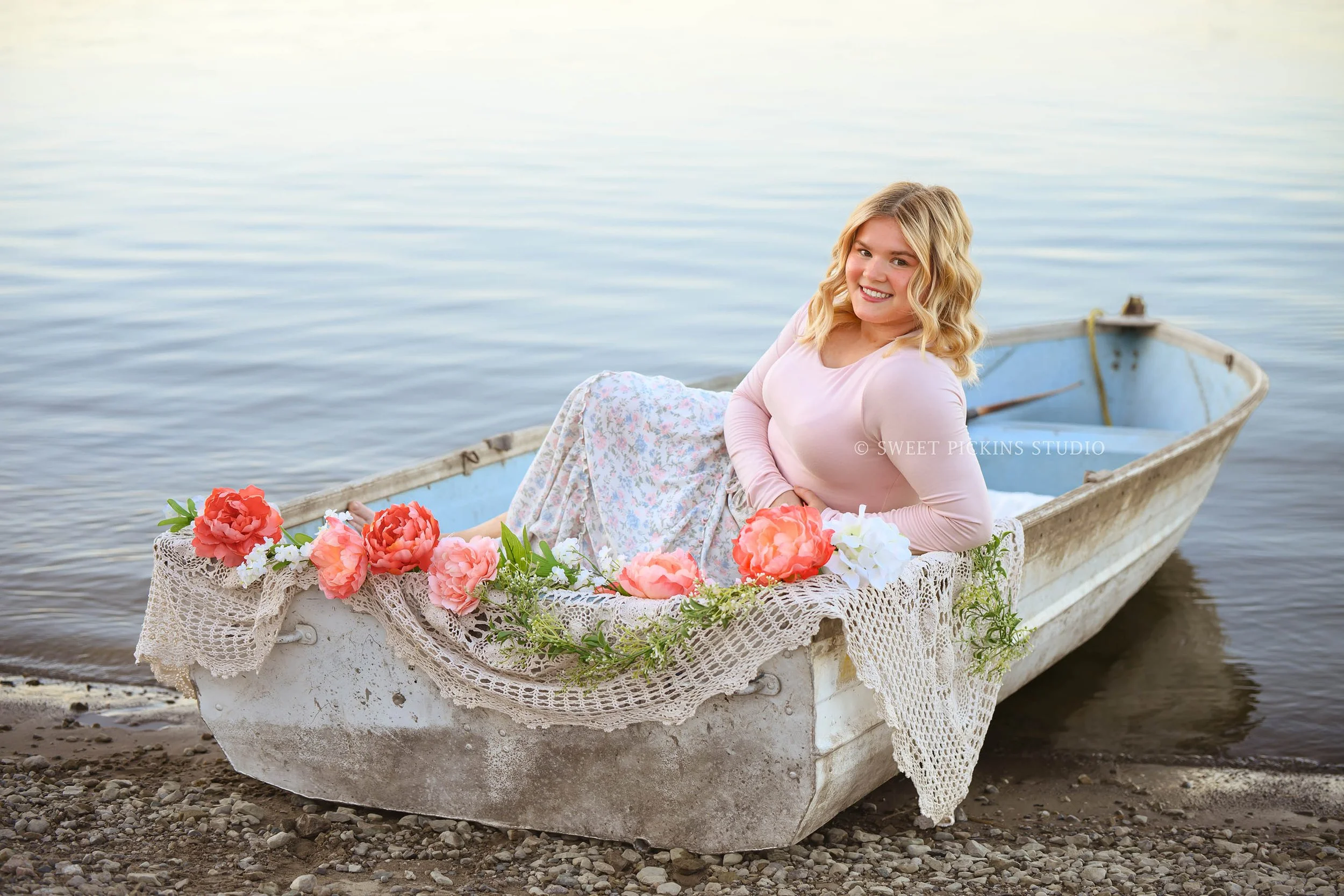 Peru Indiana Senior Photography in row boat with flowers on lake for Maconaquah class of 2027 senior girl wearing floral skirt by Sweet Pickins Studio senior photographer Amanda Wilson ©