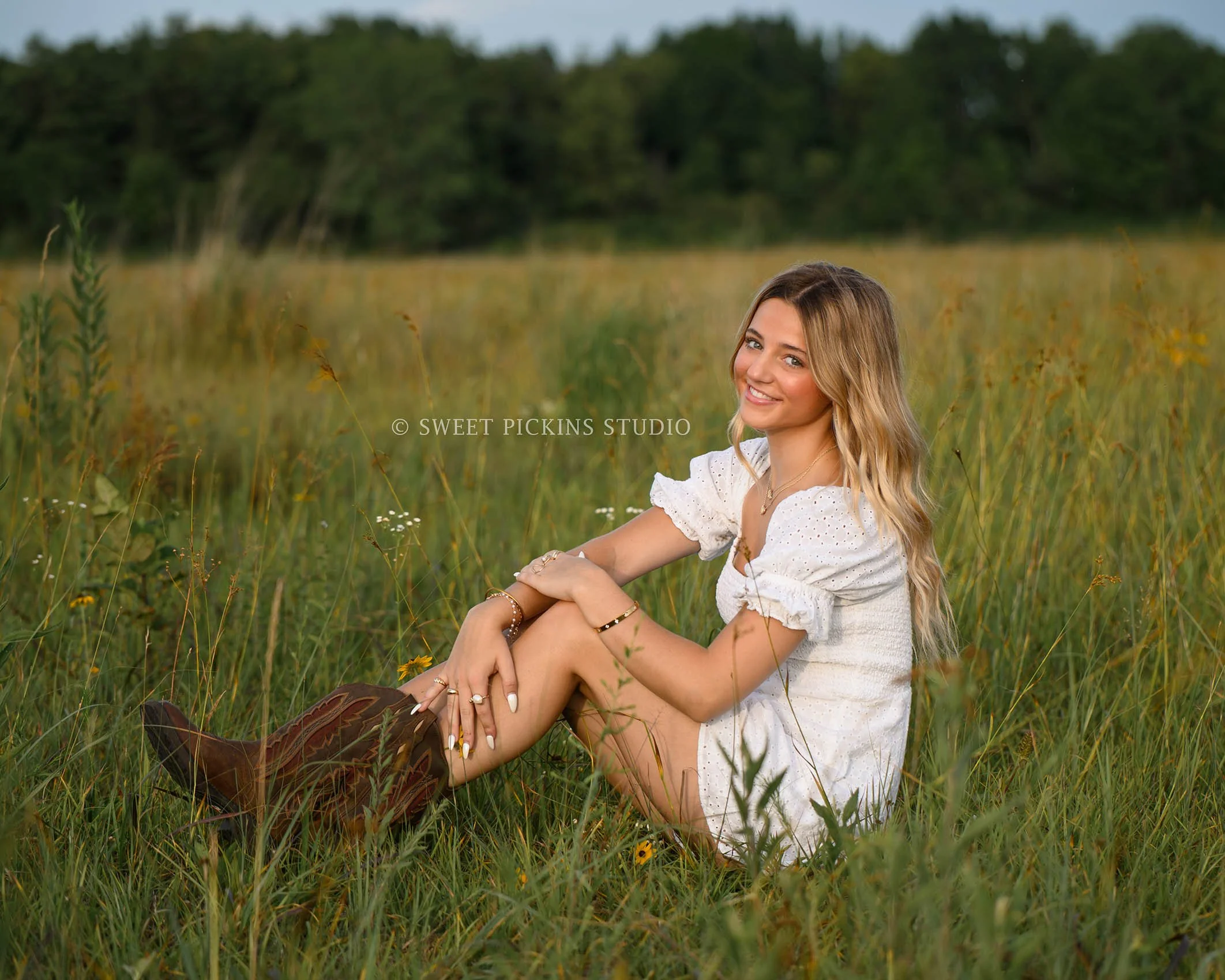 Addison’s Peru, Indiana Country Senior Photography in Prairie Flower Field at Sunset wearing white romper and western boots in summer by Sweet Pickins Studio senior photographer Amanda Wilson  ©