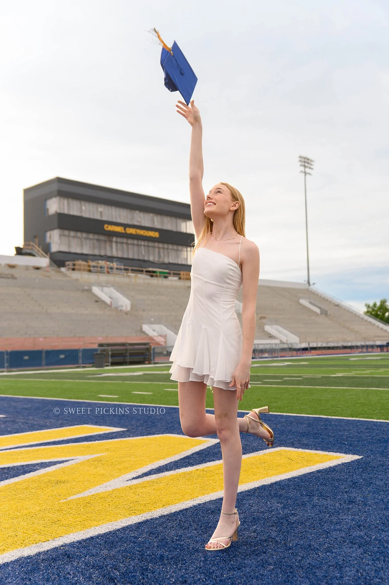 Holly and Taylor’s Carmel High School Graduation Pictures in Cap and Gown at Stadium by Sweet Pickins Studio senior photographer Amanda Wilson ©