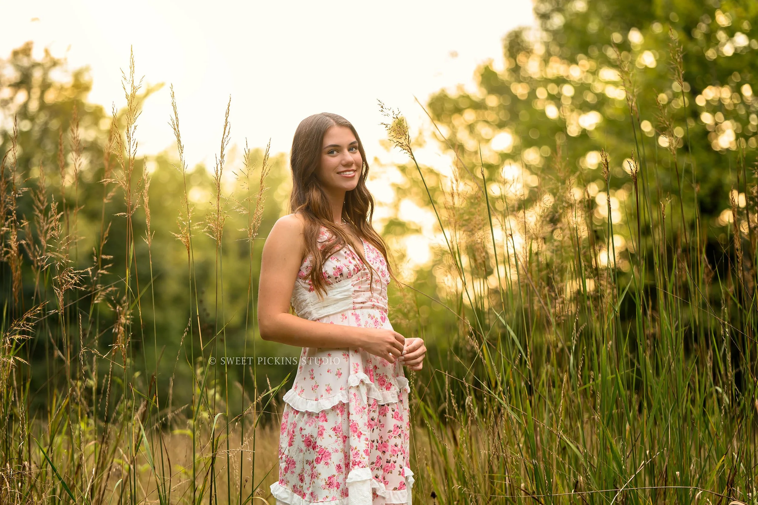 Taylor | Indiana Senior Girl Photography for class of 2027 senior in grass field wearing pink floral maxi dress at sunset by Sweet Pickins Studio senior photographer Amanda Wilson ©