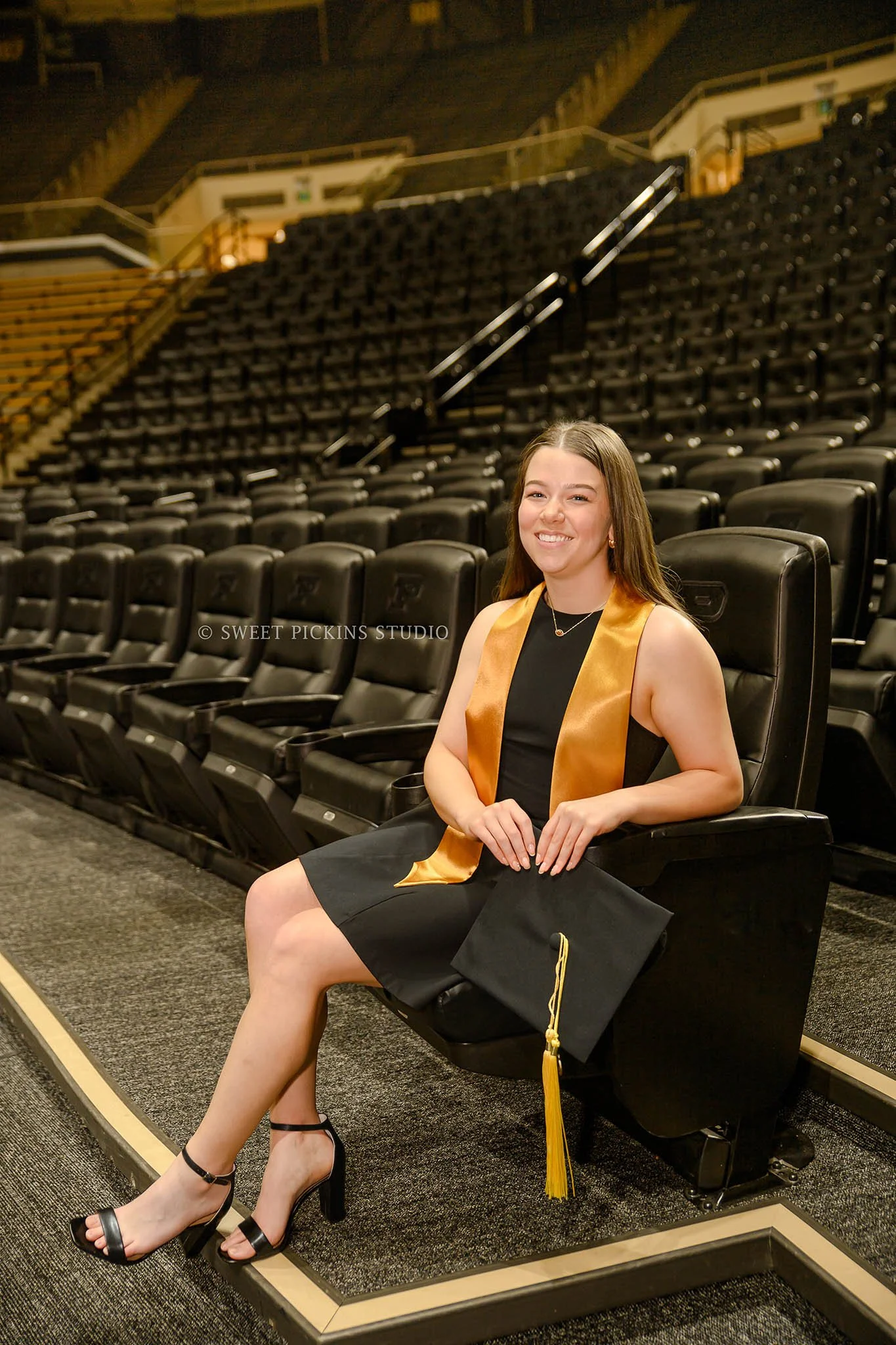 Ashelyn’s Purdue University Graduation Portrait Photography at Mackey Arena for sports nutrition graduate wearing cap and gown in West Lafayette, Indiana by Sweet Pickins Studio senior photographer Amanda Wilson © 2026