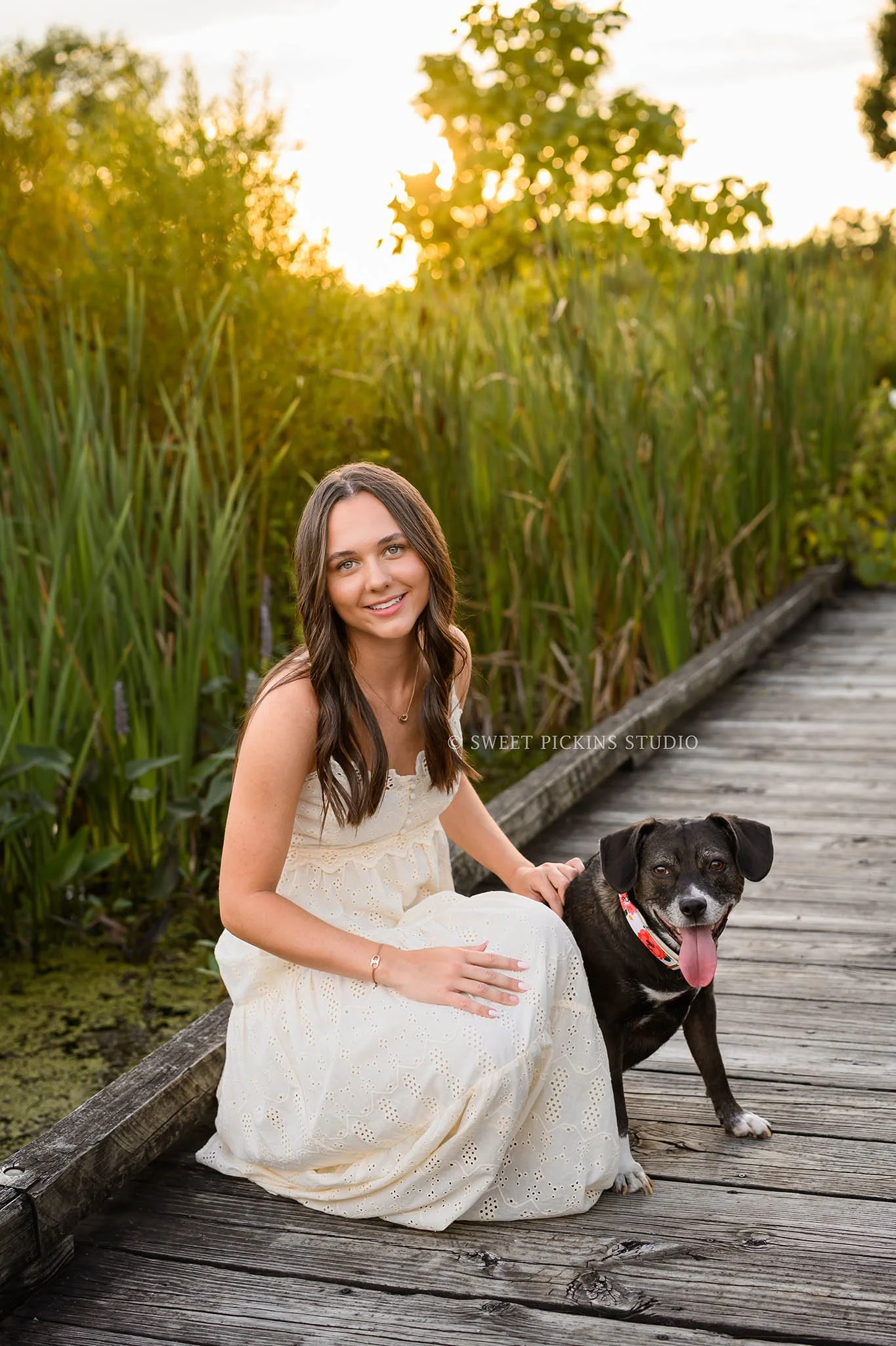 Sophie’s Carmel, Indiana Senior Photography by Sweet Pickins Studio senior photographer Amanda Wilson for class of 2027 Senior girl posing with dog in cream maxi dress at sunset ©