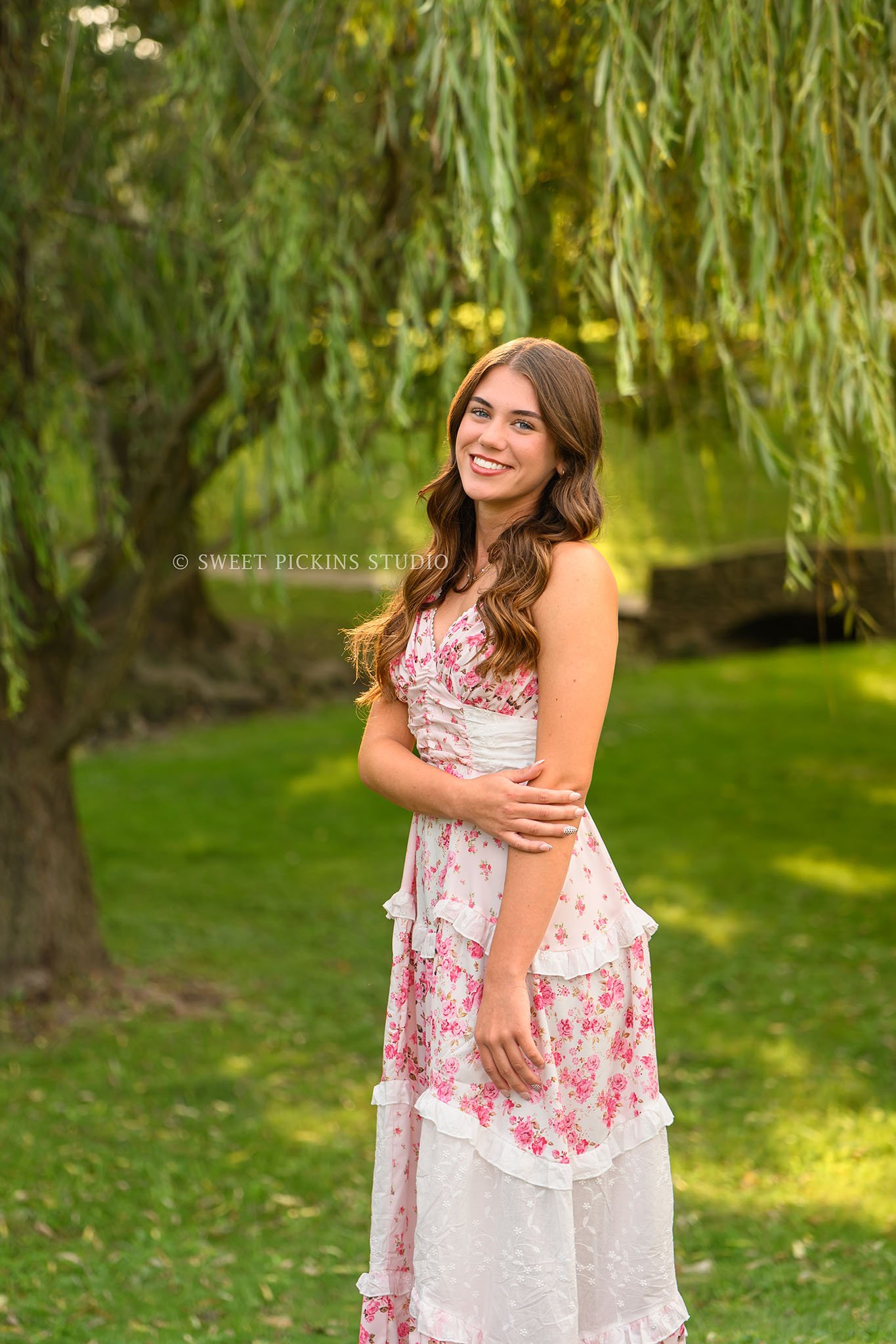 Taylor | Indiana Senior Girl Photography for class of 2027 senior posing by willow tree wearing pink floral maxi dress by Sweet Pickins Studio senior photographer Amanda Wilson ©