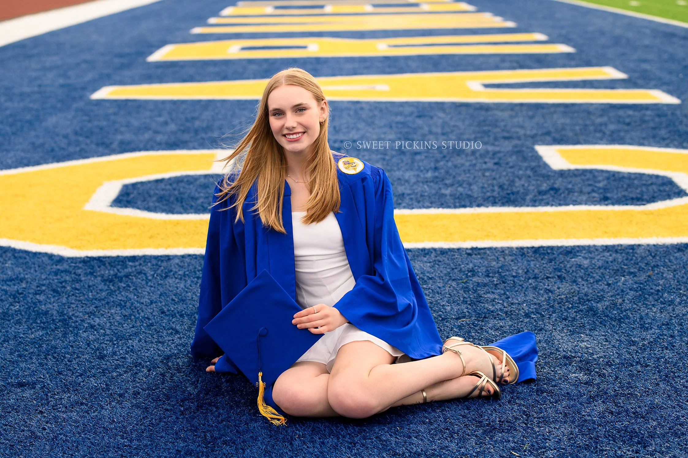 Holly and Taylor’s Carmel High School Graduation Portrait in Cap and Gown at Stadium by Sweet Pickins Studio senior photographer Amanda Wilson ©