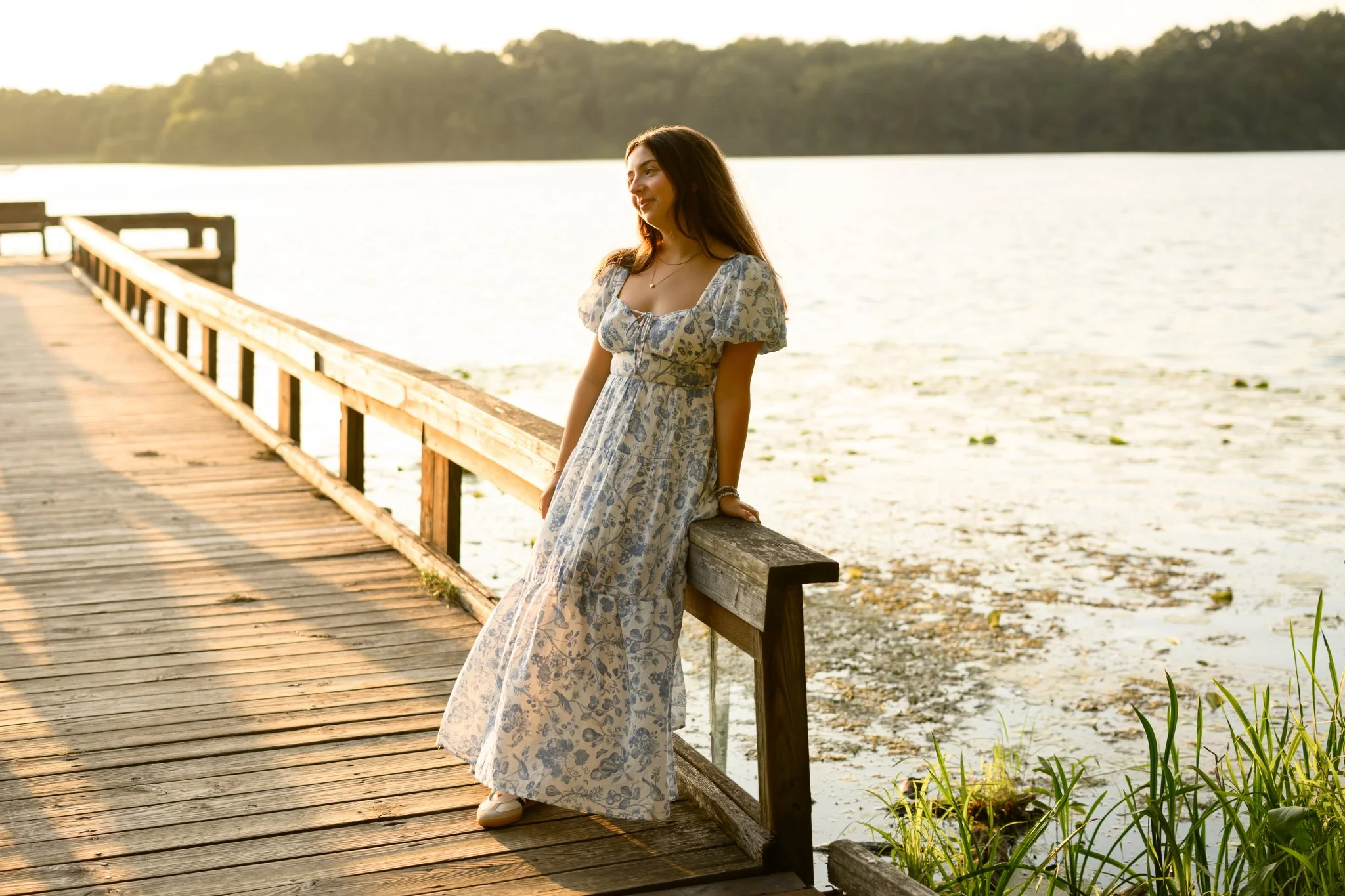 Maisie | Lakeville, Indiana Senior Photography at the Lake for Madison East High School class of 2027 senior girl posing in floral dress on pier by Peru Indiana senior photographer Amanda Wilson © Sweet Pickins Studio
