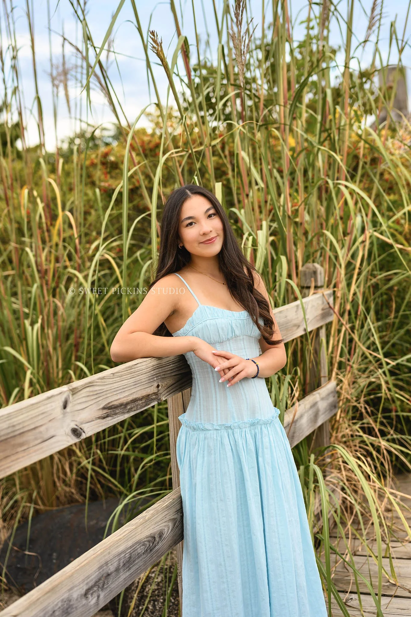 Nora | Carmel, Indiana Senior Girl Portraits posing on bridge wearing blue dress for Park Tudor Class of 2027 by Sweet Pickins Studio senior photographer Amanda Wilson ©