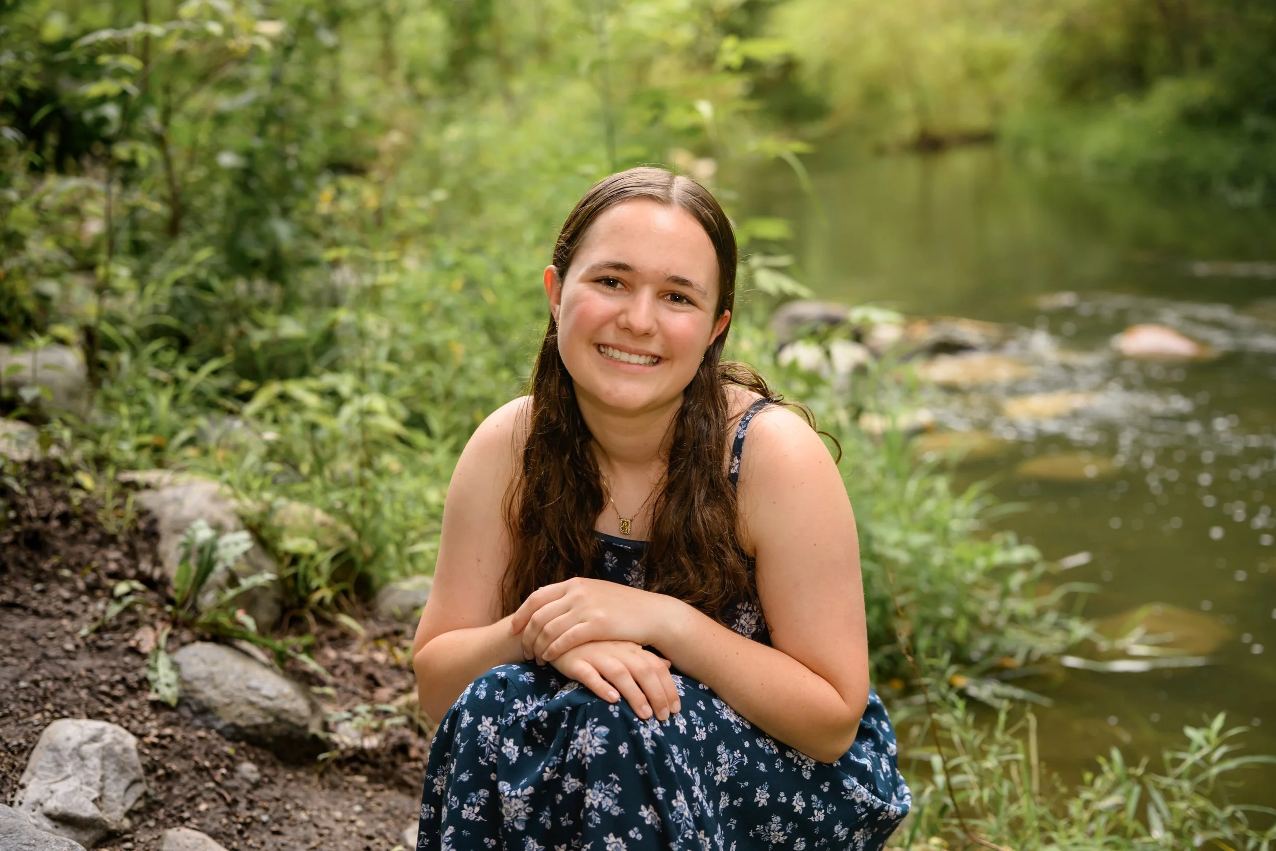 Carmel, Indiana Senior Photography for Class of 2027 Senior Ellen in Creek water wearing floral romper in summer by Sweet Pickins Studio senior photographer Amanda Wilson ©